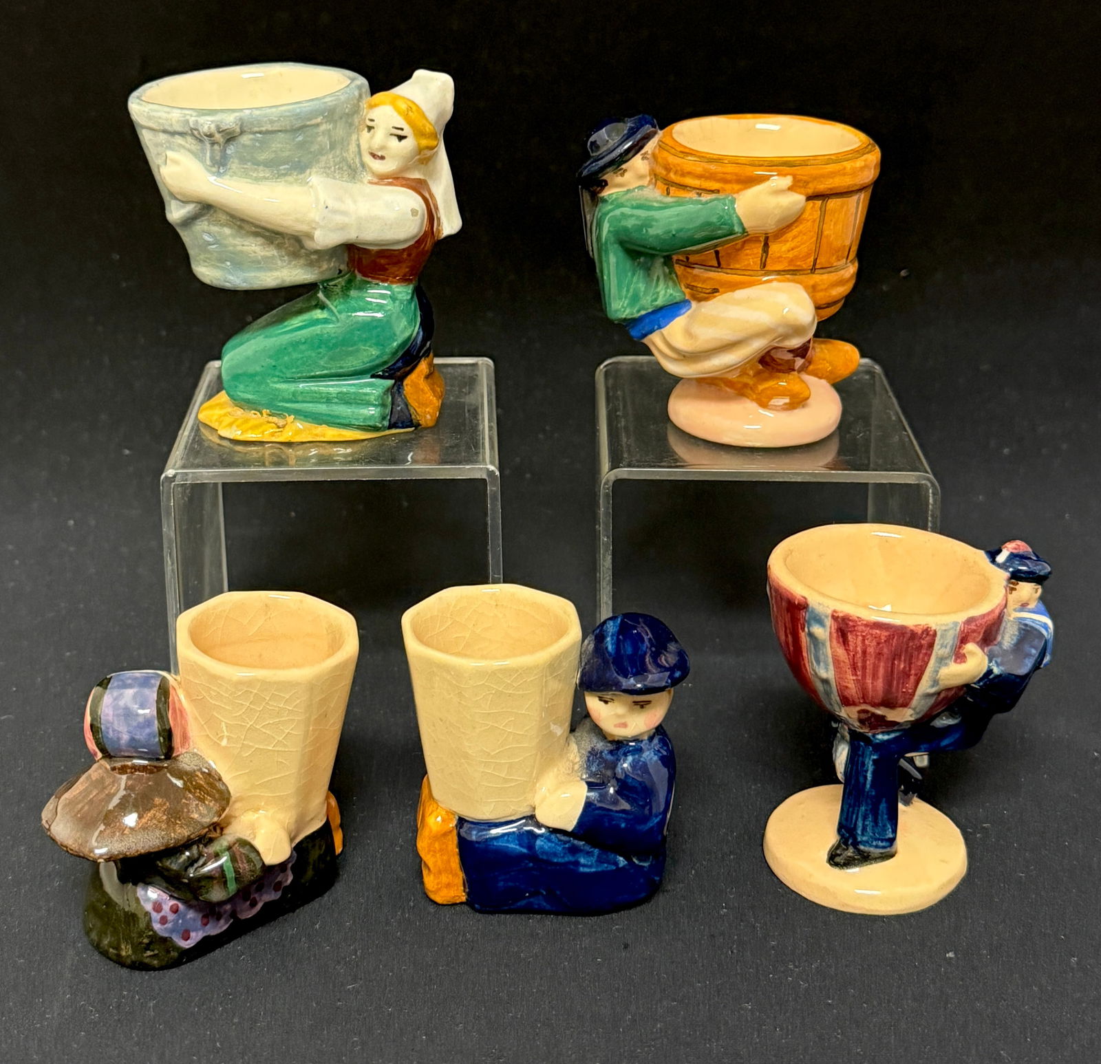 5 Charles Maillard HenRiot Items: 5 Charles Maillard HenRiot Quimper French faience Modern Movement eggs cups and match holder with figural children, Bretons and a sailor; tallest ht 3 1/8". CONDITION: couple of chips to feet, see pic