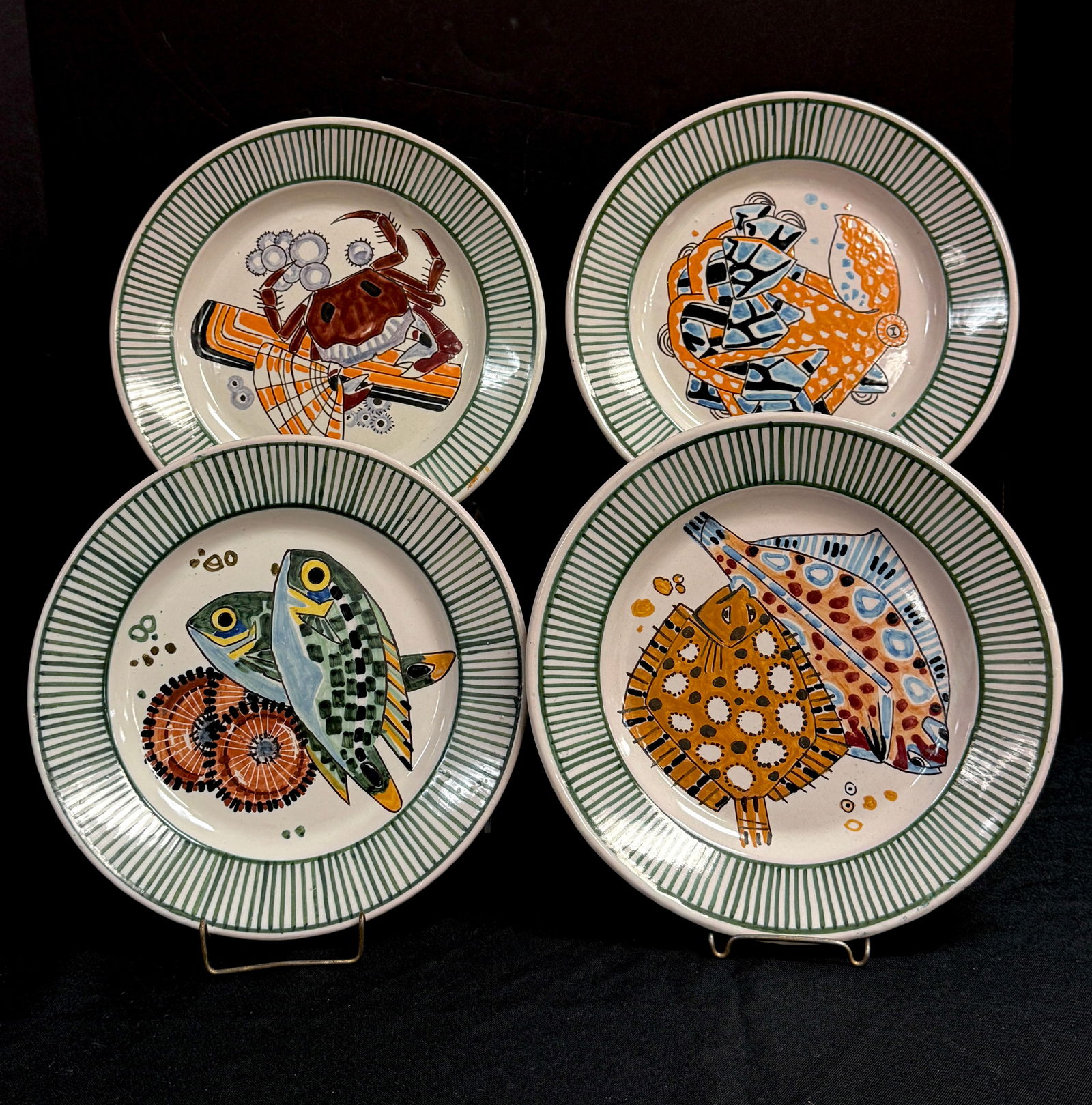 4 Mathurin Meheut Sea Life Plates: Mathurin Meheut HenRiot Quimper French faience sea life series dinner plates including crab, octopus, flounder, and fish and shells; diameter 9 1/2". CONDITION: Quimper has propensity to have minor ch