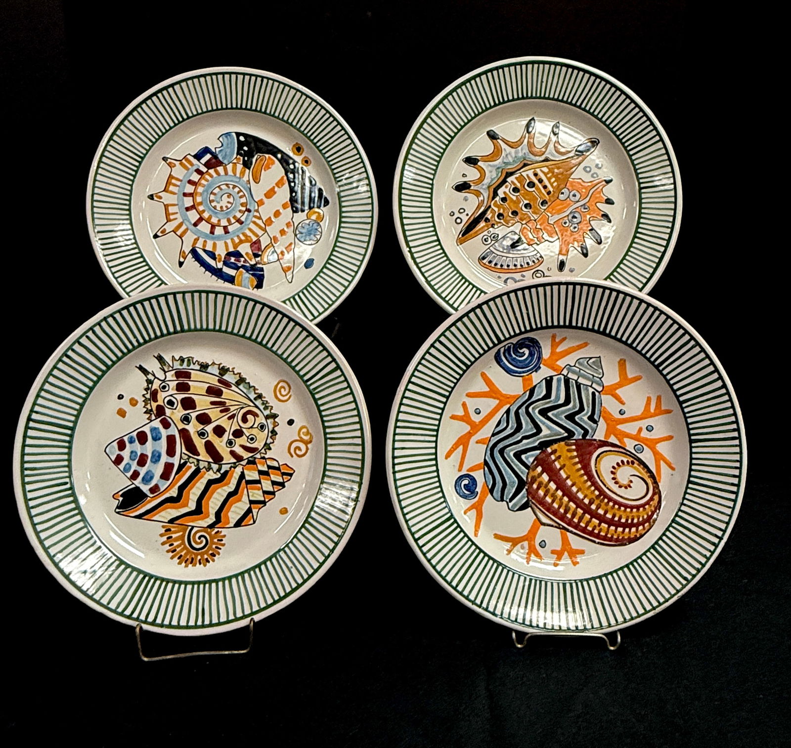 4 Mathurin Meheut Plates: 4 Mathurin Meheut HenRiot Quimper French faience dinner plates with assorted seashells; diameter 9 1/2". CONDITION: one plate has small chip on underside of rim.
