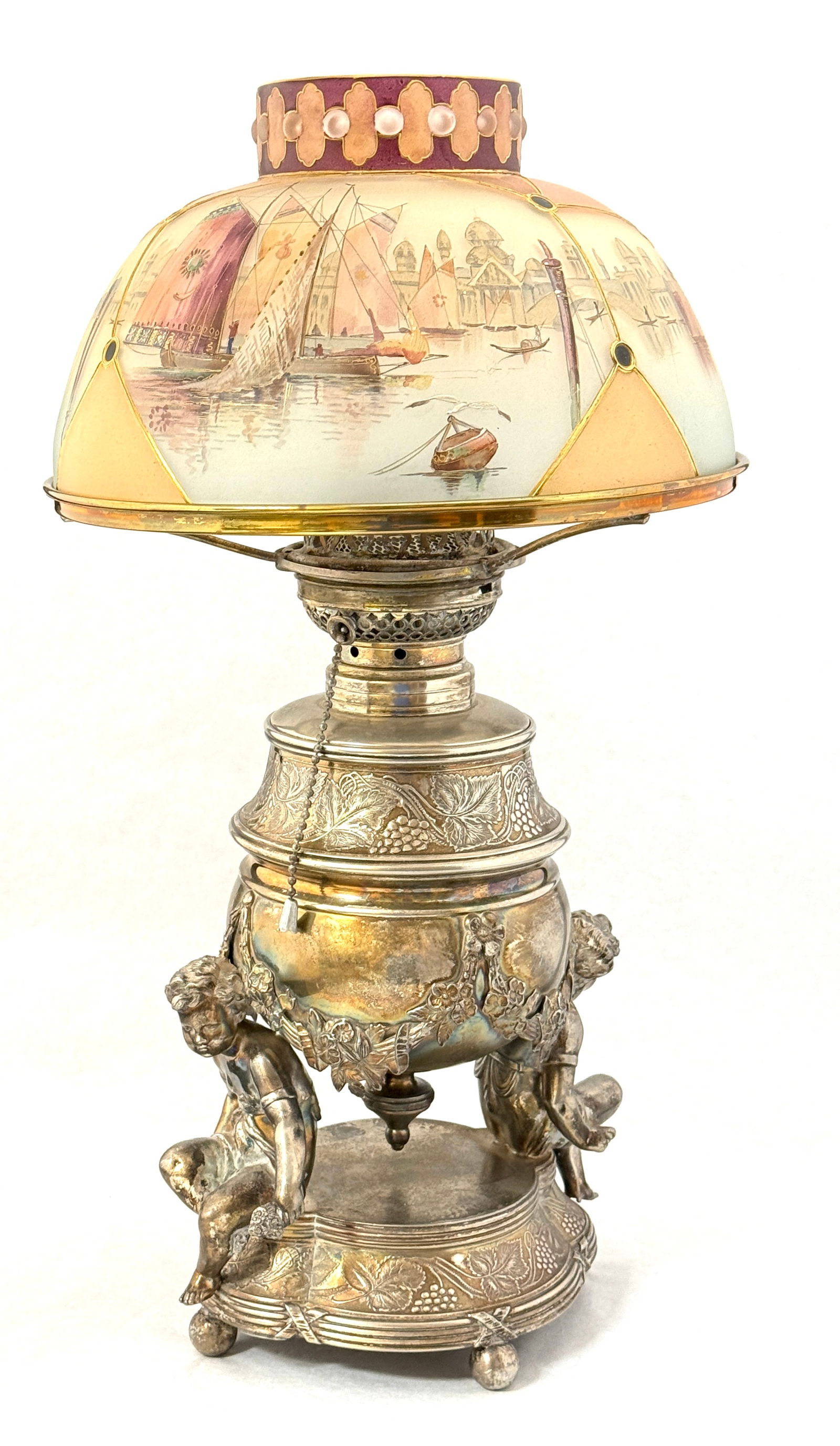 Gorgeous Royal Flemish Lamp: Gorgeous Royal Flemish Lamp, shade with 5 panels of sail boats and sea gulls on a stamped Pairpoint metal base with putti and garland; ht. 19". CONDITION: repair to the shade