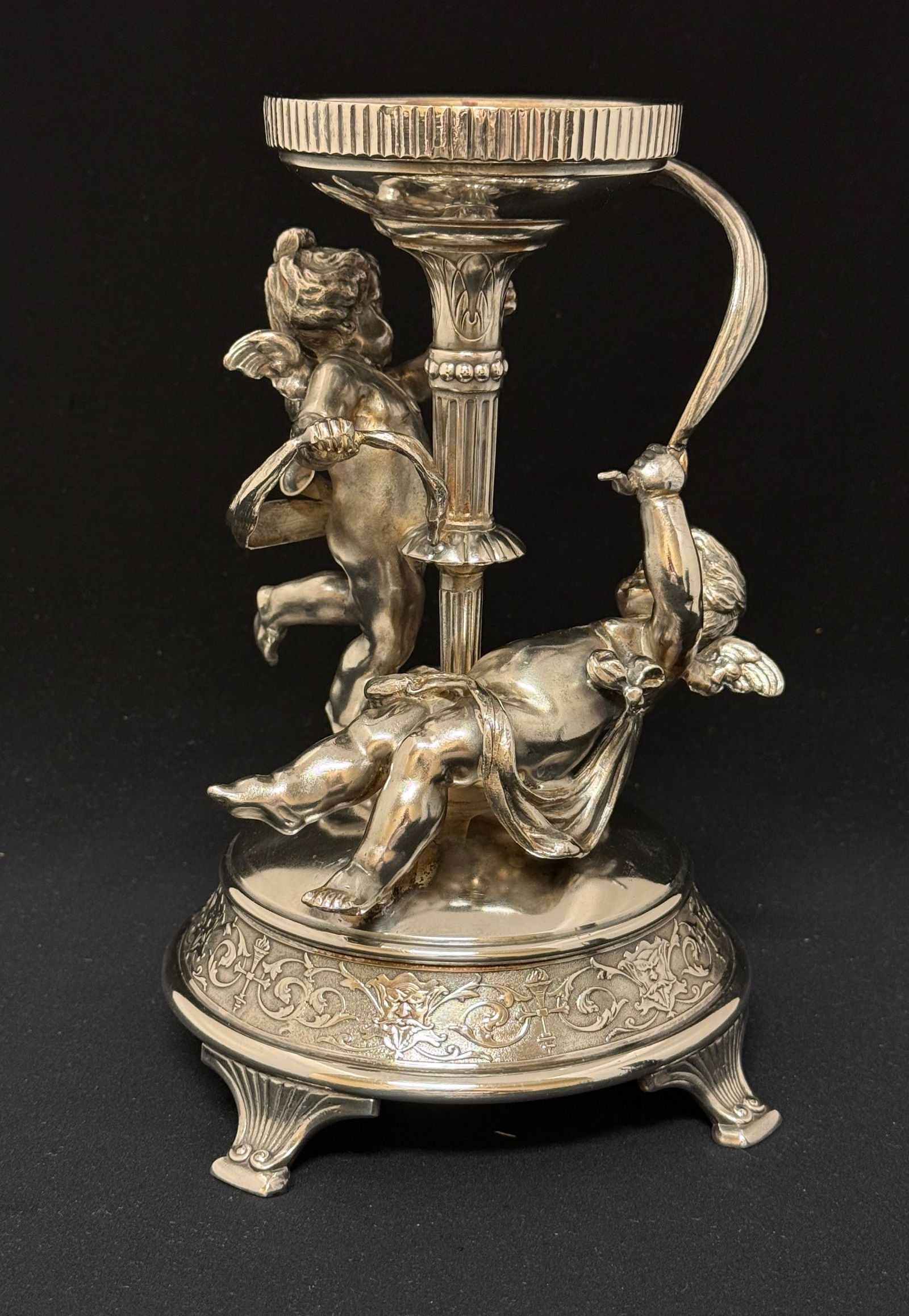 Pairpoint Cherub metal holder: Pairpoint silverplate metal holder with two Cherubs, 9 1/2" ht. CONDITION: no chips, cracks, repairs or material defects found, Jaremos attempts to call any material flaw that affects the price, but m