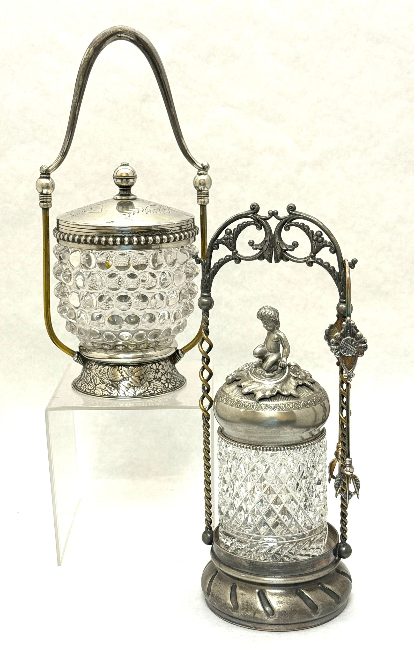 2 Victorian Pickle Castors: 2 Victorian crystal pickle castors, one hobnail with Derby Silver Company holder the other a diamond quilt pattern in a marked Pairpoint holder and ornate lid with putti marked Italy and fork; tallest