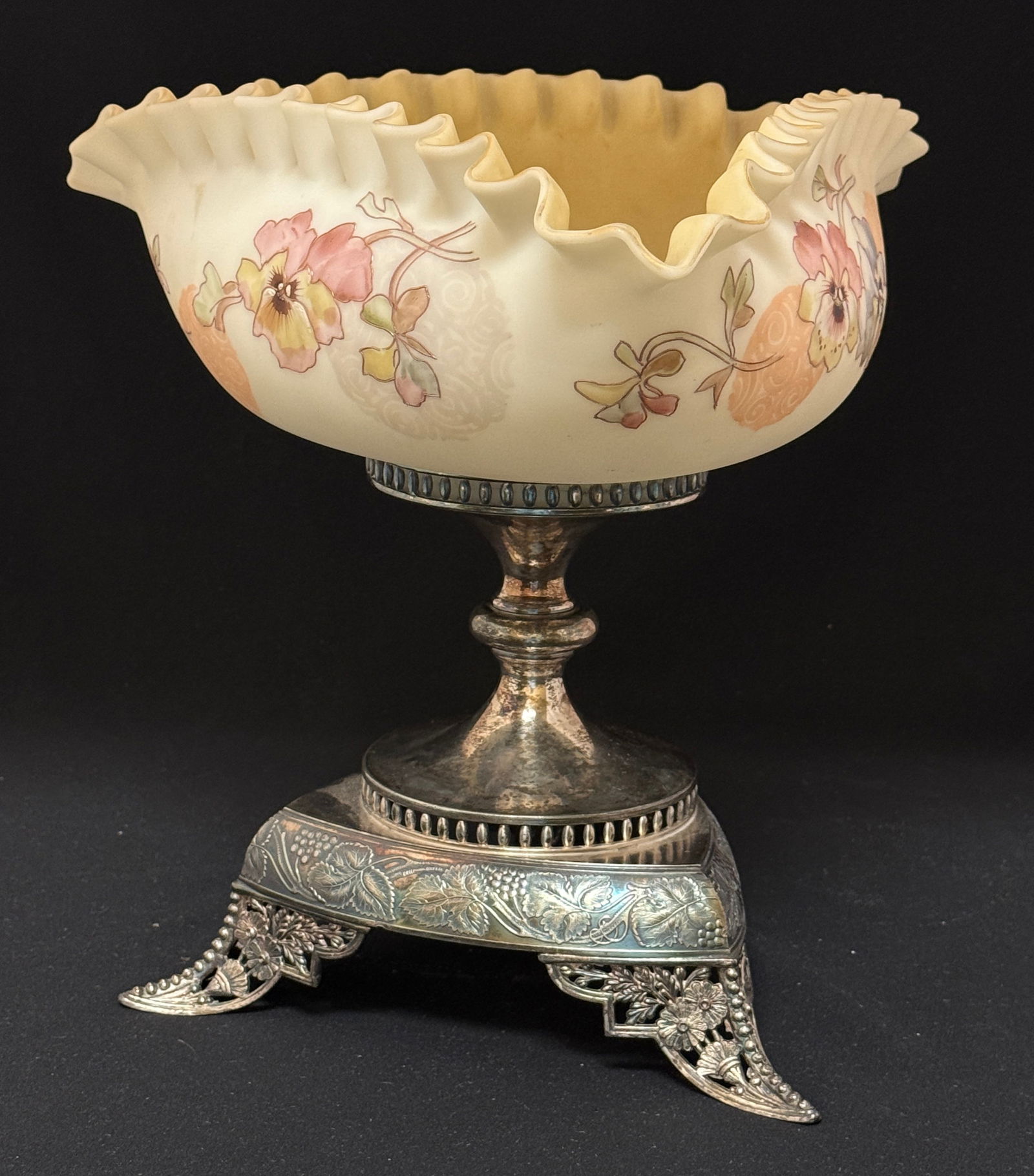 Crown Milano Brides Basket: Lovely Crown Milano tri-cornered bride's basket with enameled pansies set in a marked Pairpoint holder; ht 11 1/8". CONDITION: no chips, cracks, repairs or material defects found, Jaremos attempts to