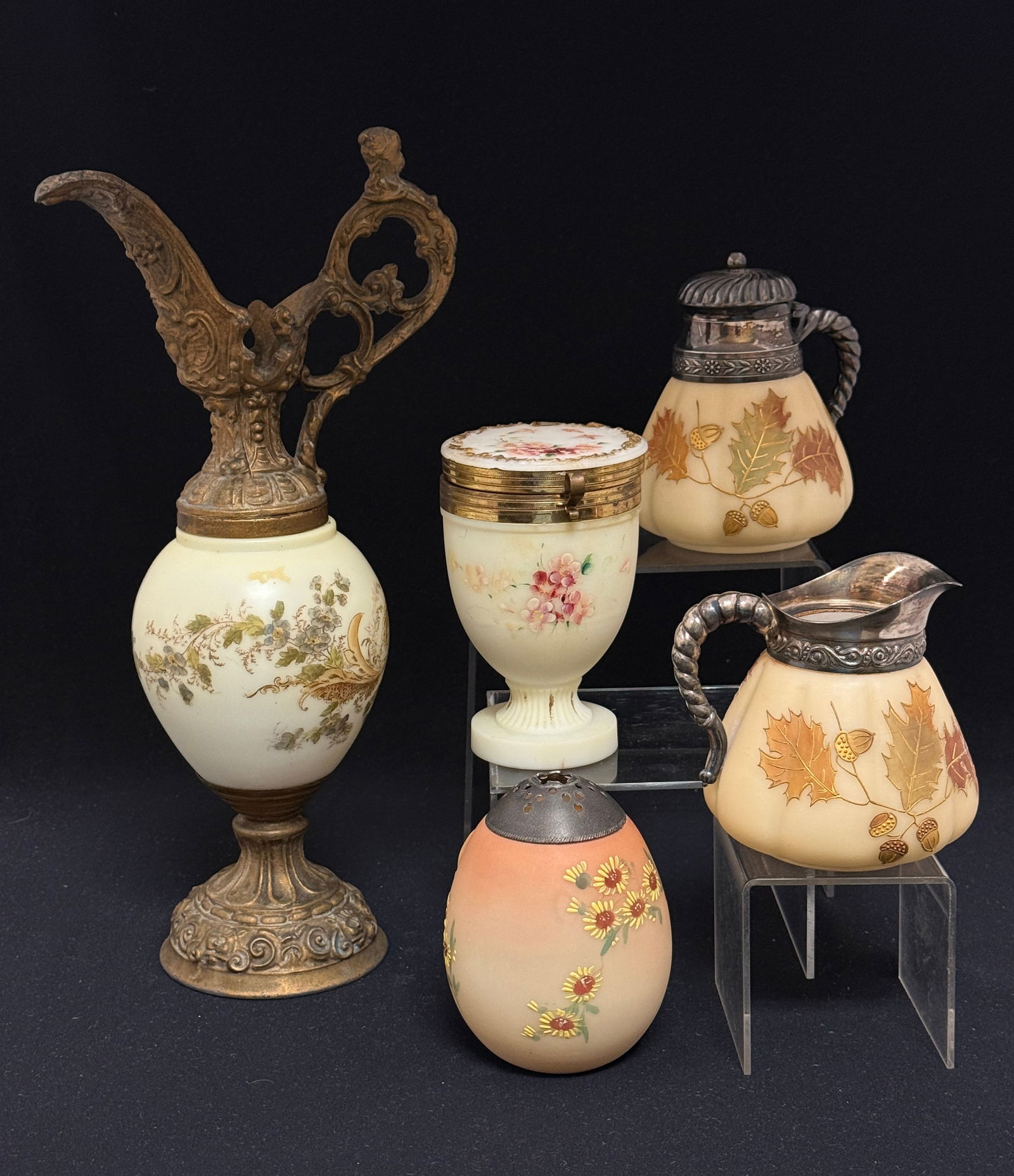 5 Victorian Enameled Items: 5 Victorian enameled items including a Mt Washington creamer and sugar, Mt. Washington muffineer, a Wavecrest ewer and a Pairpoint covered jar; tallest 13". CONDITION: Muffineer has cut opening on lid