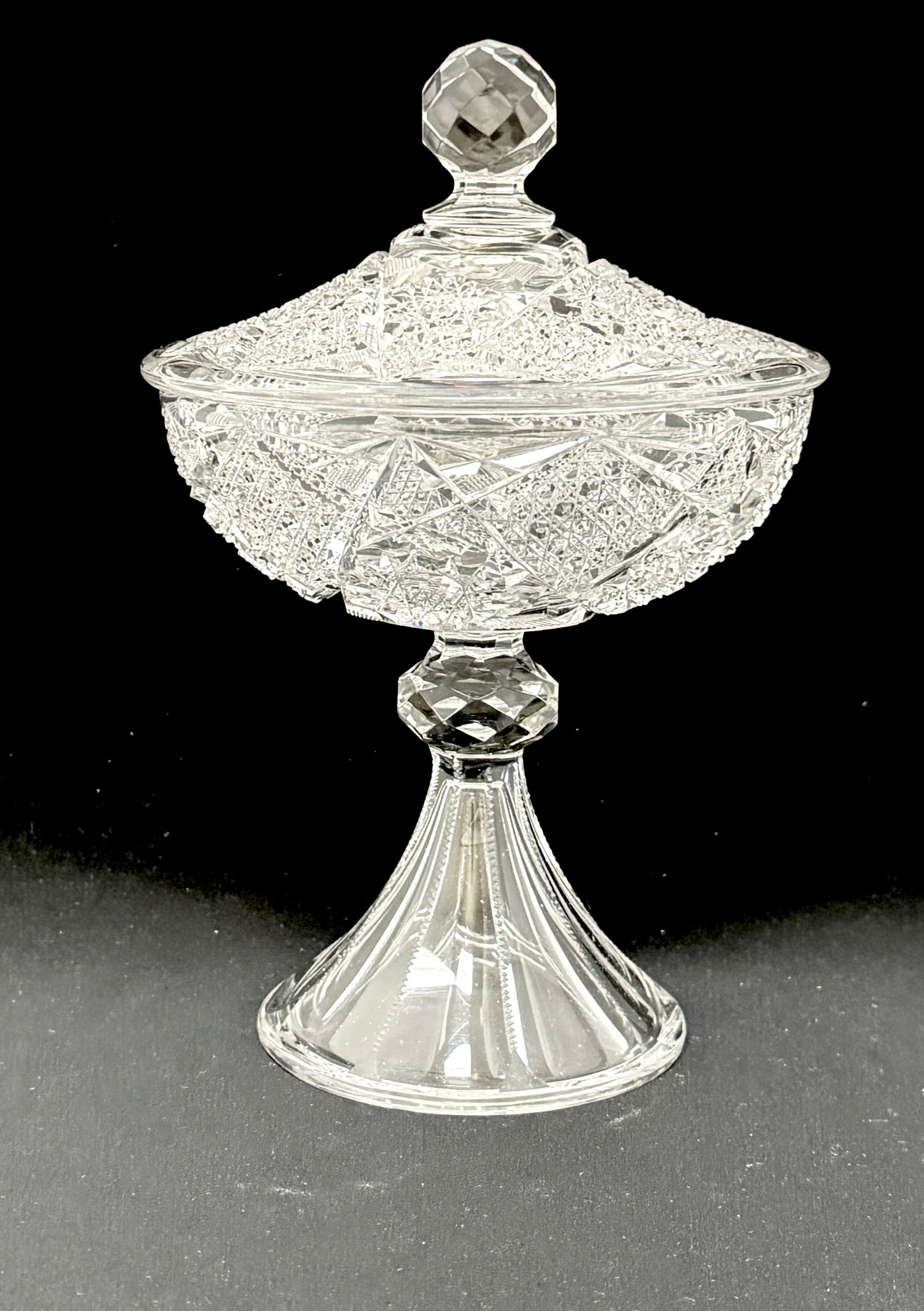 American Brilliant Cut Compote: American Brilliant Cut Glass Compote with cane and stars with a cut flaring foot and faceted standard, 10" ht. CONDITION: no chips, cracks, repairs or material defects found. Jaremos attempts to call