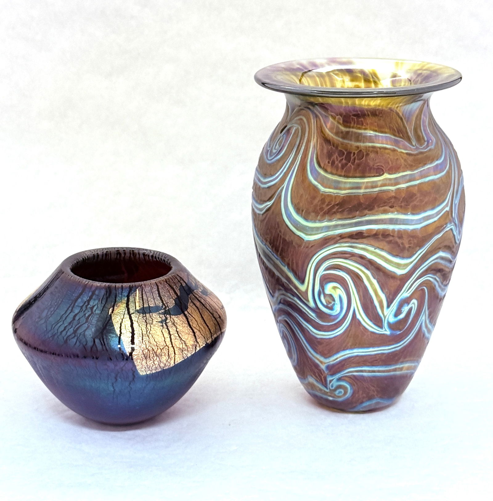 2 Eickholt Vases: 2 Eickholt vases one King Tut iridescent purple with an ovoid purple squat vase with splashes of gold, signed Eickholt; tallest 7 1/2". CONDITION: no chips, cracks, repairs, or material defects found,
