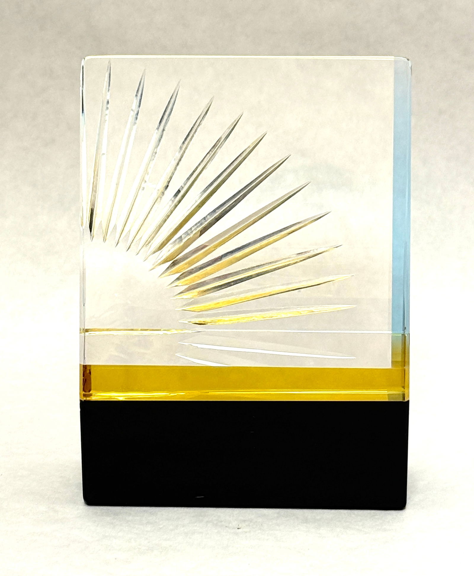 Denali Sunburst Paperweight: Denali yellow sunburst pyramid on black base paperweight, signed Denali 25/30 IMCERA; diameter 4" ht 5 7/8". PROVENANCE: from the collection of Mark Chamovitz. CONDITION: no chips, cracks, repairs or