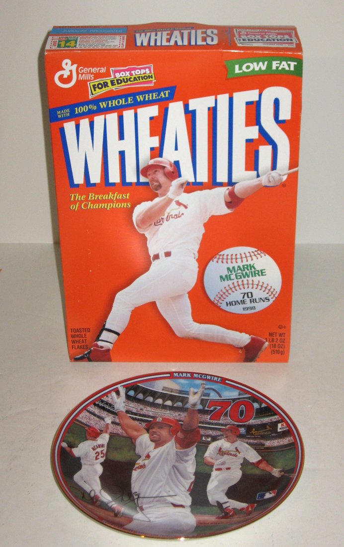 Group of Mark McGwire items,: including a record 70 home run plate, an un-opened Wheaties box and a collection of Tulsa newspapers heralding the race between McGwire and Sosa from 63 home runs to the conclusion. A St. Louis paper