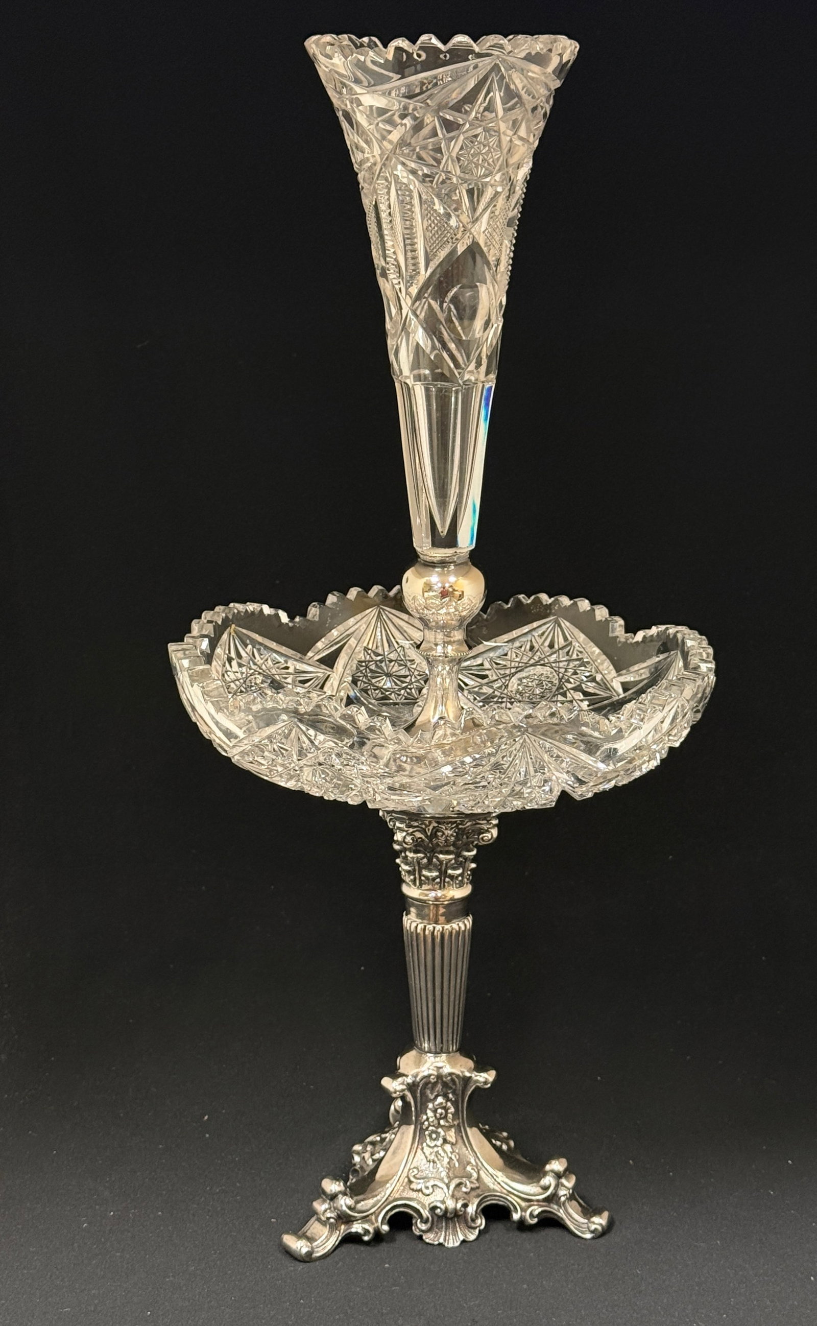 Cut Glass Epergne: Magnificent cut glass epergne with a scrolling silver plate standard and a cut glass bowl and trumpet, 20" ht. CONDITION: no chips, cracks, repairs, or material defects found, Jaremos attempts to call