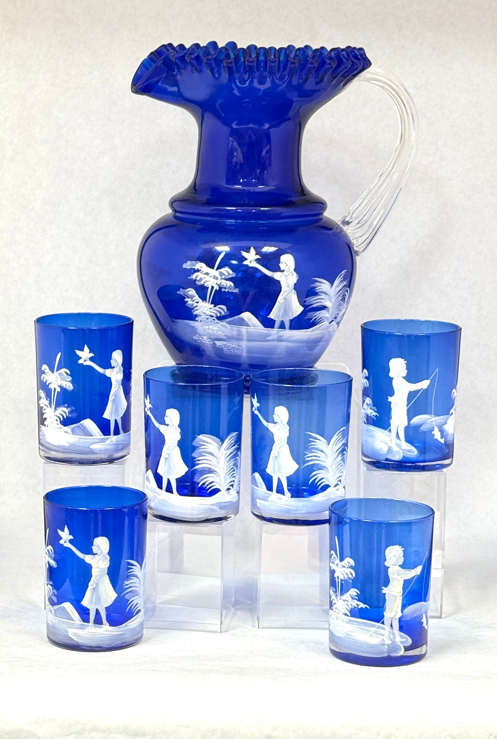 Mary Gregory Cobalt Water Set: Mary Gregory cobalt water set, pitcher with 6 tumblers; ht. 9 3/4". CONDITION: no chips, cracks, repairs, or material defects found, Jaremos attempts to call any material flaw that affects the price,