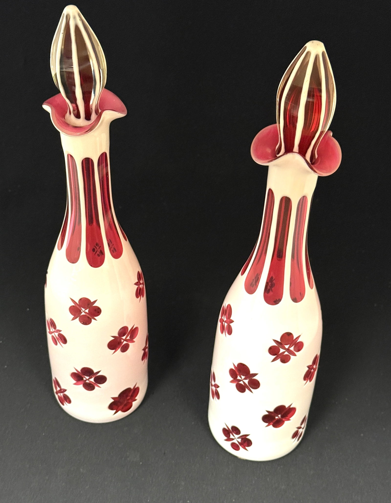 Pair of Opal Cut to Cranberry: Pair of Opal cut to cranberry bottles in a cross and dot pattern, 14" ht. CONDITION: no chips, cracks, repairs, or material defects found, Jaremos attempts to call any material flaw that affects the p