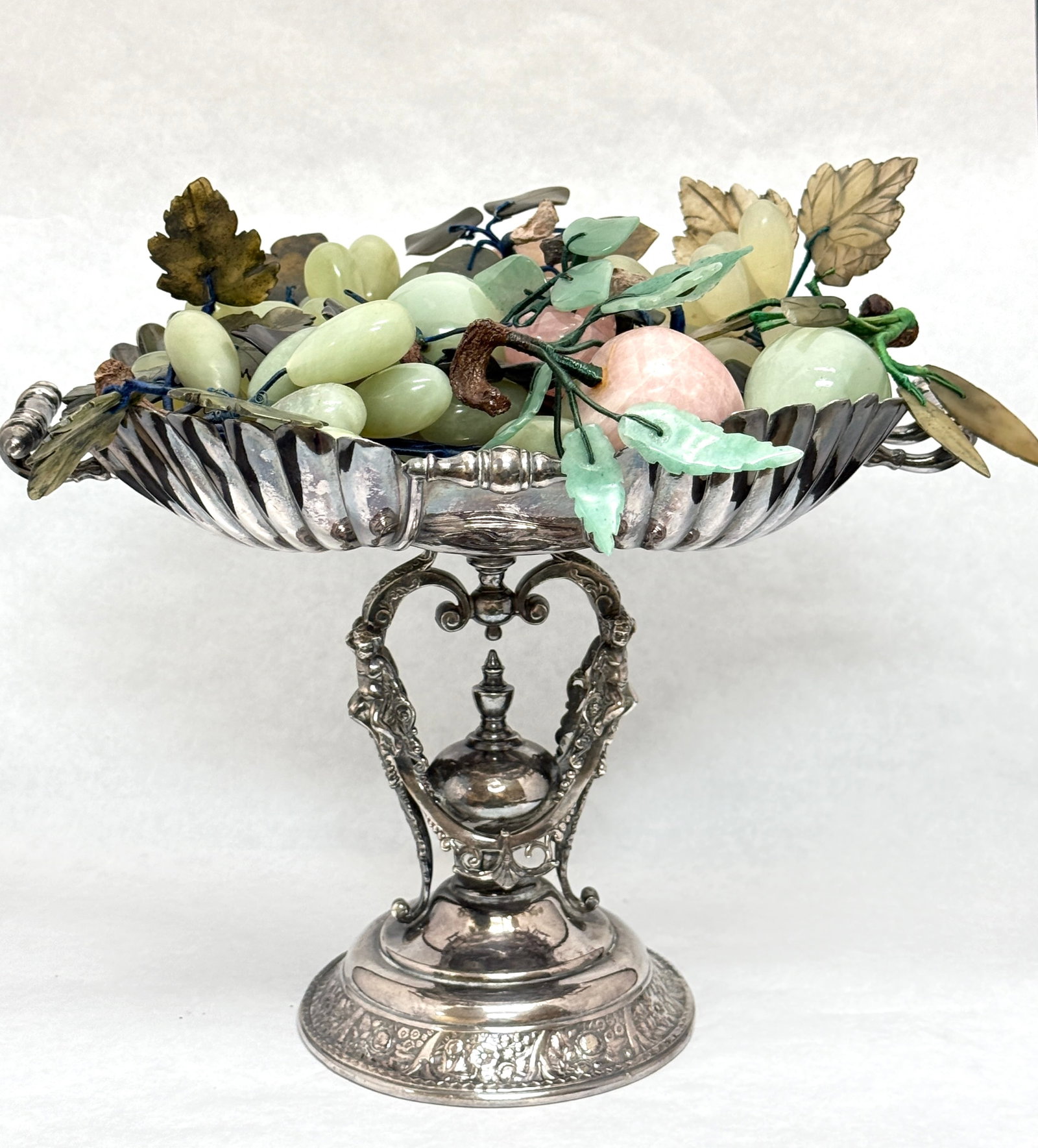 2 Handle Wilcox Compote: 2 handled Wilcox silver plate compote with alabaster fruit; ht. 10". CONDITION: no chips, cracks, repairs, or material defects found, Jaremos attempts to call any material flaw that affects the