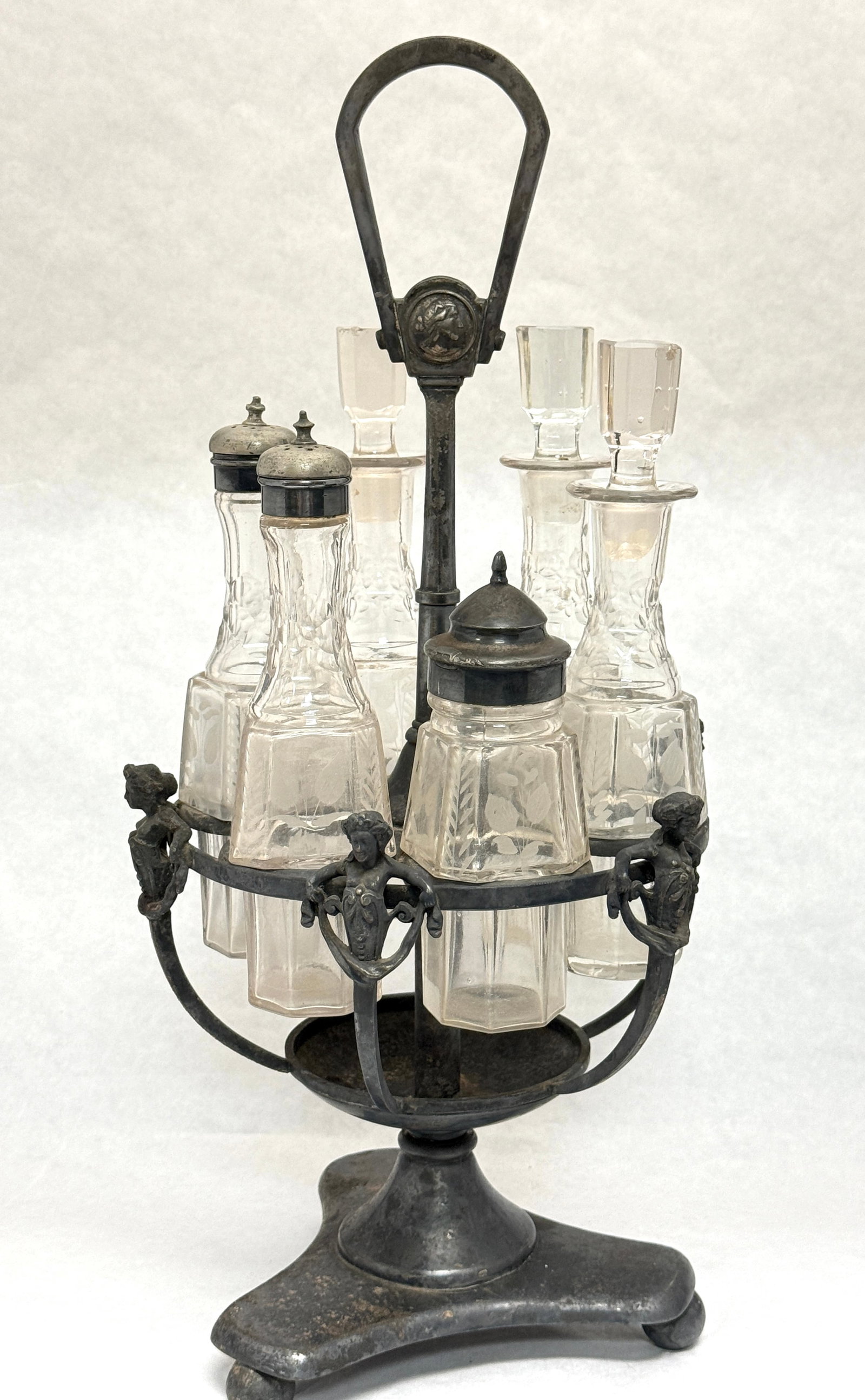 Glass and Metal Cruet Set: Glass and metal cruet set, 17" ht. CONDITION: no chips, cracks, repairs, or material defects found, Jaremos attempts to call any material flaw that affects the price, but minor scratches and color