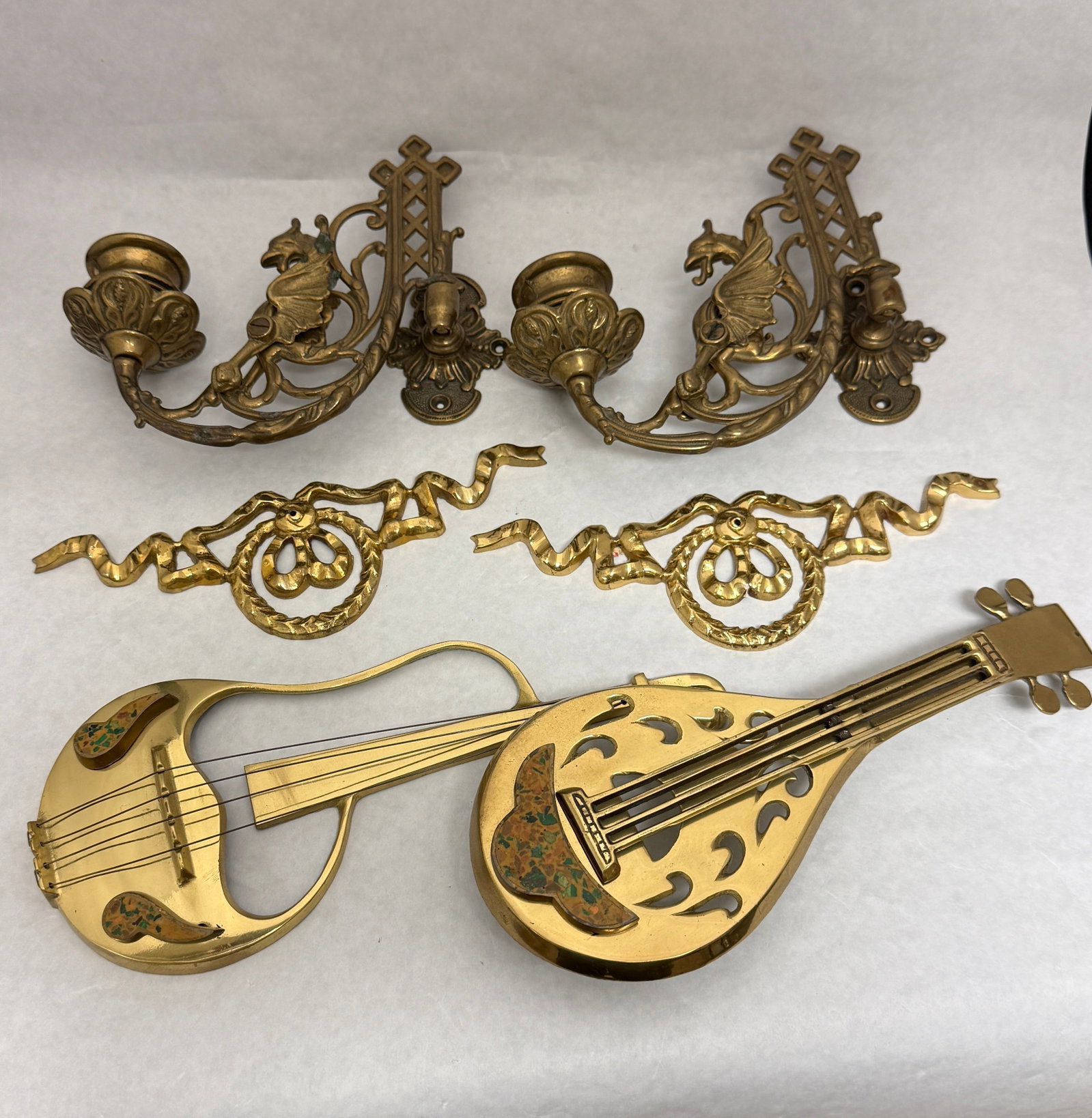 Group of Brass Items: Group of brass items including two candle sconces and furniture ornaments; sconces 6 1/2" long. CONDITION: no chips, cracks, repairs, or material defects found, Jaremos attempts to call any material