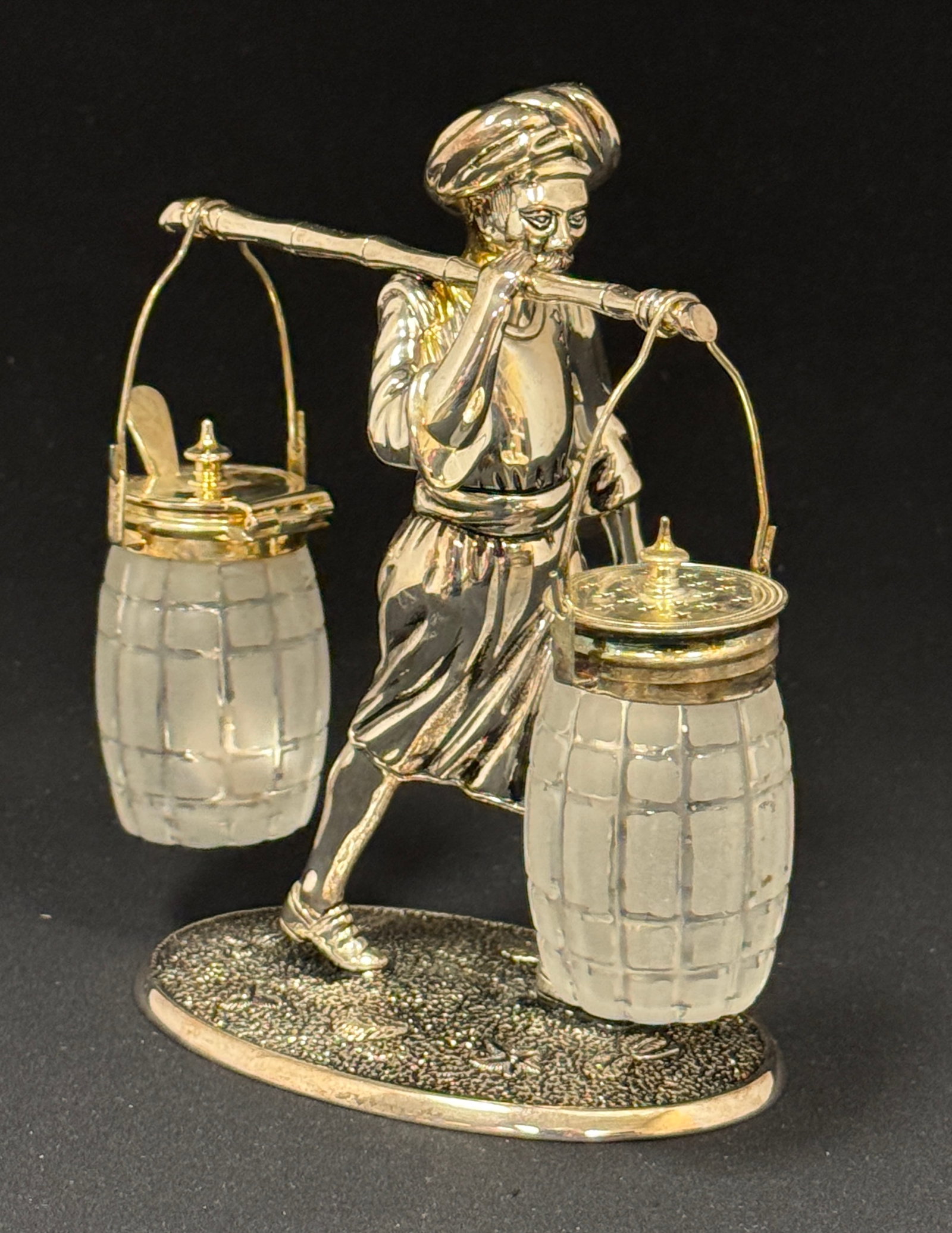 Hanging Salt and Pepper Shakers: Hanging salt and pepper shakers on a silver plate figural condiment caddy; ht. 6 1/2". CONDITION: no chips, cracks, repairs, or material defects found, Jaremos attempts to call any material flaw that