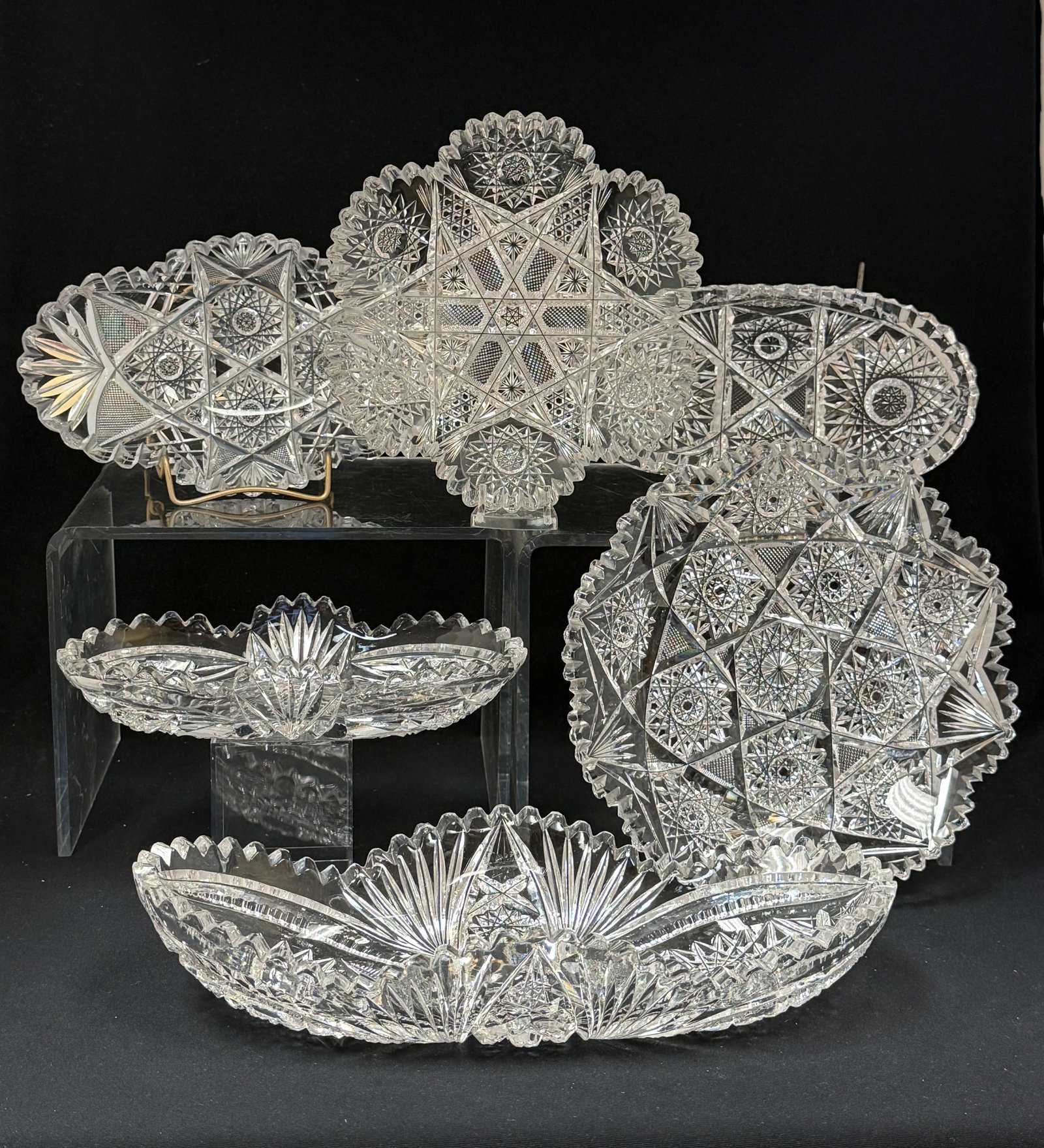 6 Cut Glass Items: 4 cut glass olive trays together with 2 dishes; length of longest 11". CONDITION: no chips, cracks, repairs, or material defects found, Jaremos attempts to call any material flaw that affects the