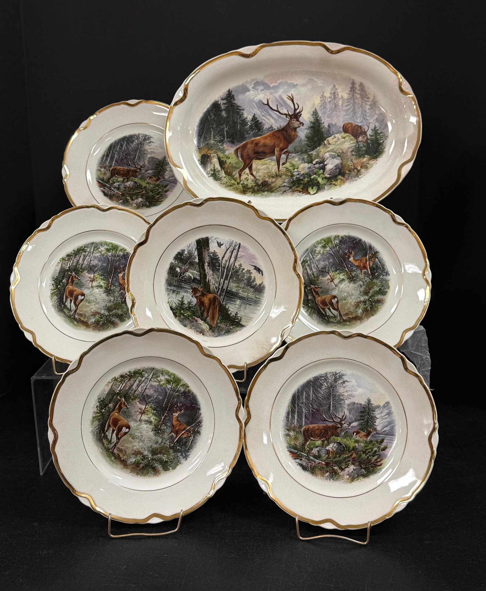 7 Dresden China Items: 7 Dresden China items with deer, elk and fox motif, including a platter and 6 plates; platter length 13 1/2". CONDITION: slight crazing no chips, cracks, repairs, or material defects found, Jaremos at