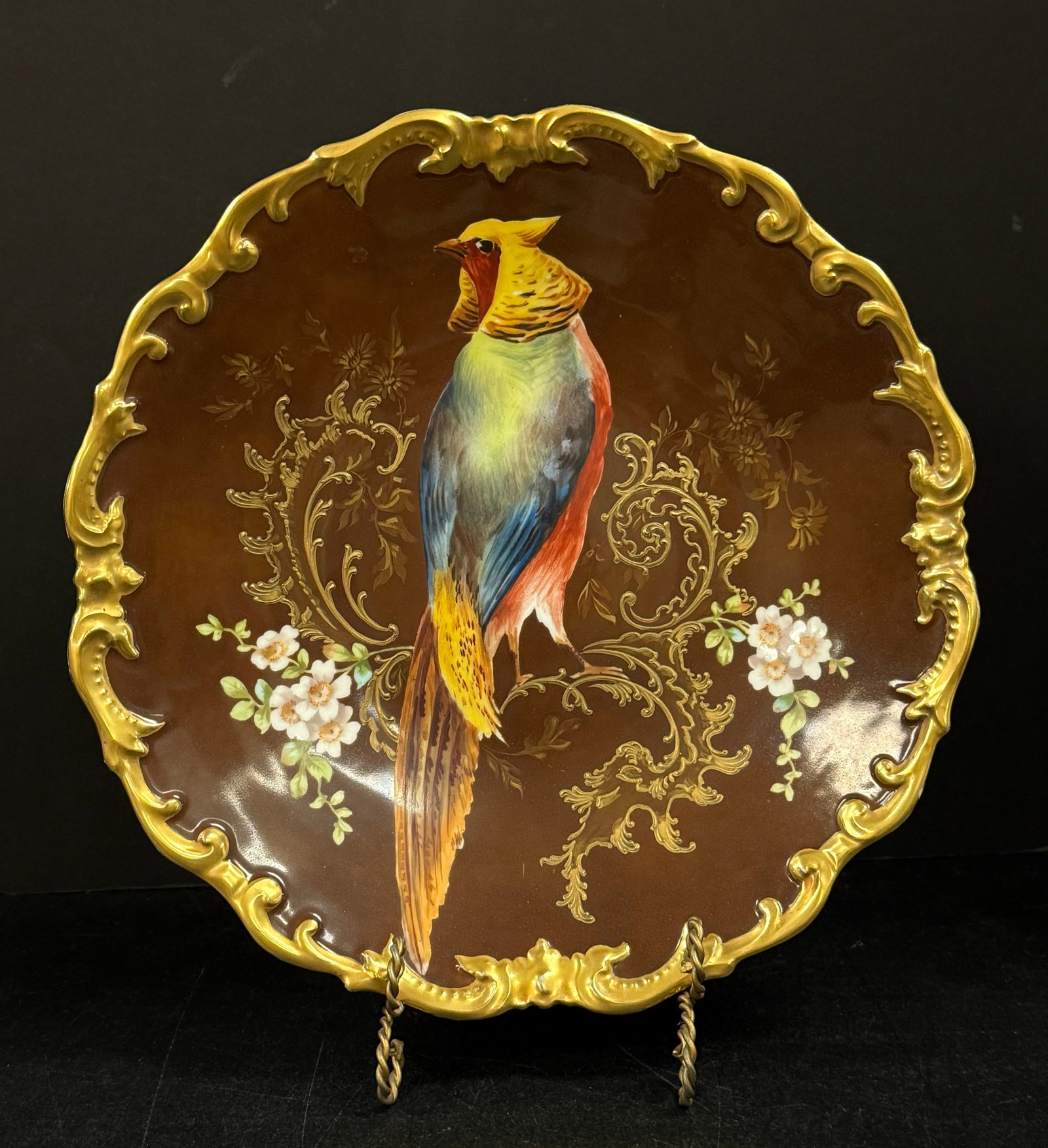 Limoges Oval Plate with Parrot: Limoges oval plate with colorful parrot and gold heavily embossed rim; diameter 13 1/4". CONDITION: no chips, cracks, repairs, or material defects found, Jaremos attempts to call any material flaw tha