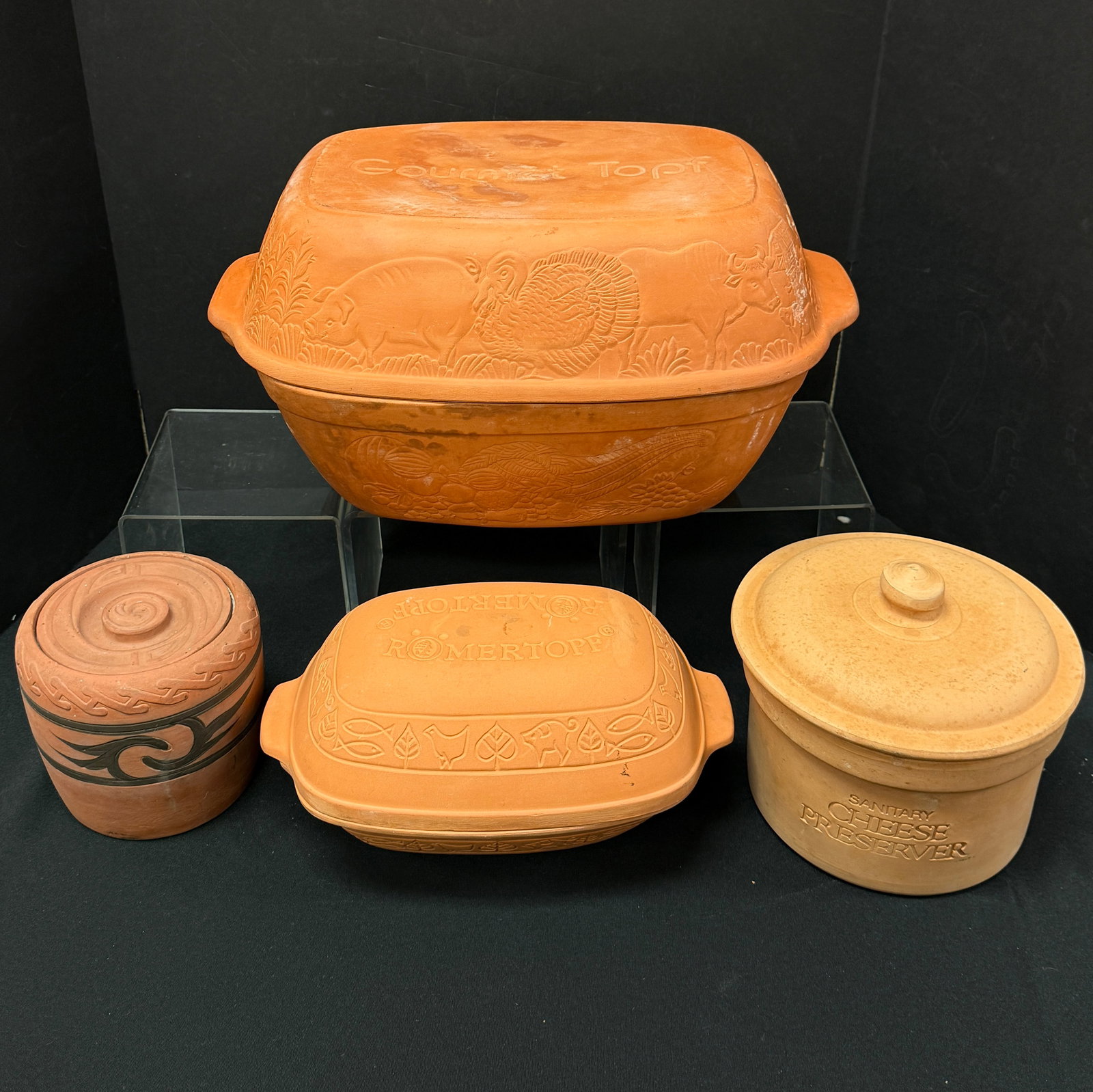 Terre Cotta/clay cooking items: Large Gourmet Topf #312 clay Dutch oven, 16 3/4" length, 11" width, together with a Romertopf clay Dutch oven #110 11 1/4" long, a cheese preserver with ceramic interior and a Clifton Indianware