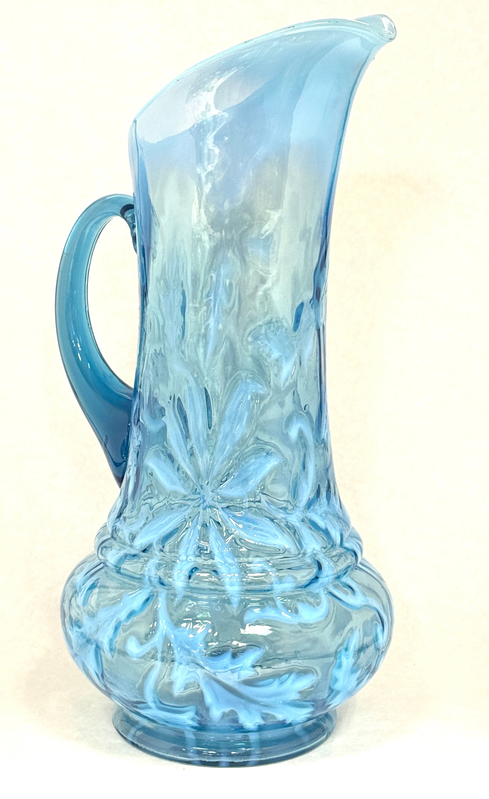 Opalescent Poinsettia Tankard: Opalescent blue poinsettia tankard; ht. 13". CONDITION: no chips, cracks, repairs, or material defects found, Jaremos attempts to call any material flaw that affects the price, but minor scratches