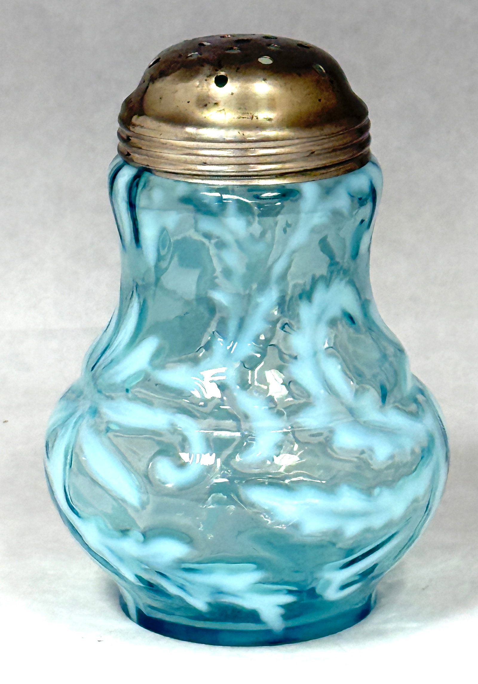 Opalescent Poinsettia Shaker: Opalescent blue poinsettia sugar shaker; ht. 5". CONDITION: no chips, cracks, repairs, or material defects found, Jaremos attempts to call any material flaw that affects the price, but minor scratches