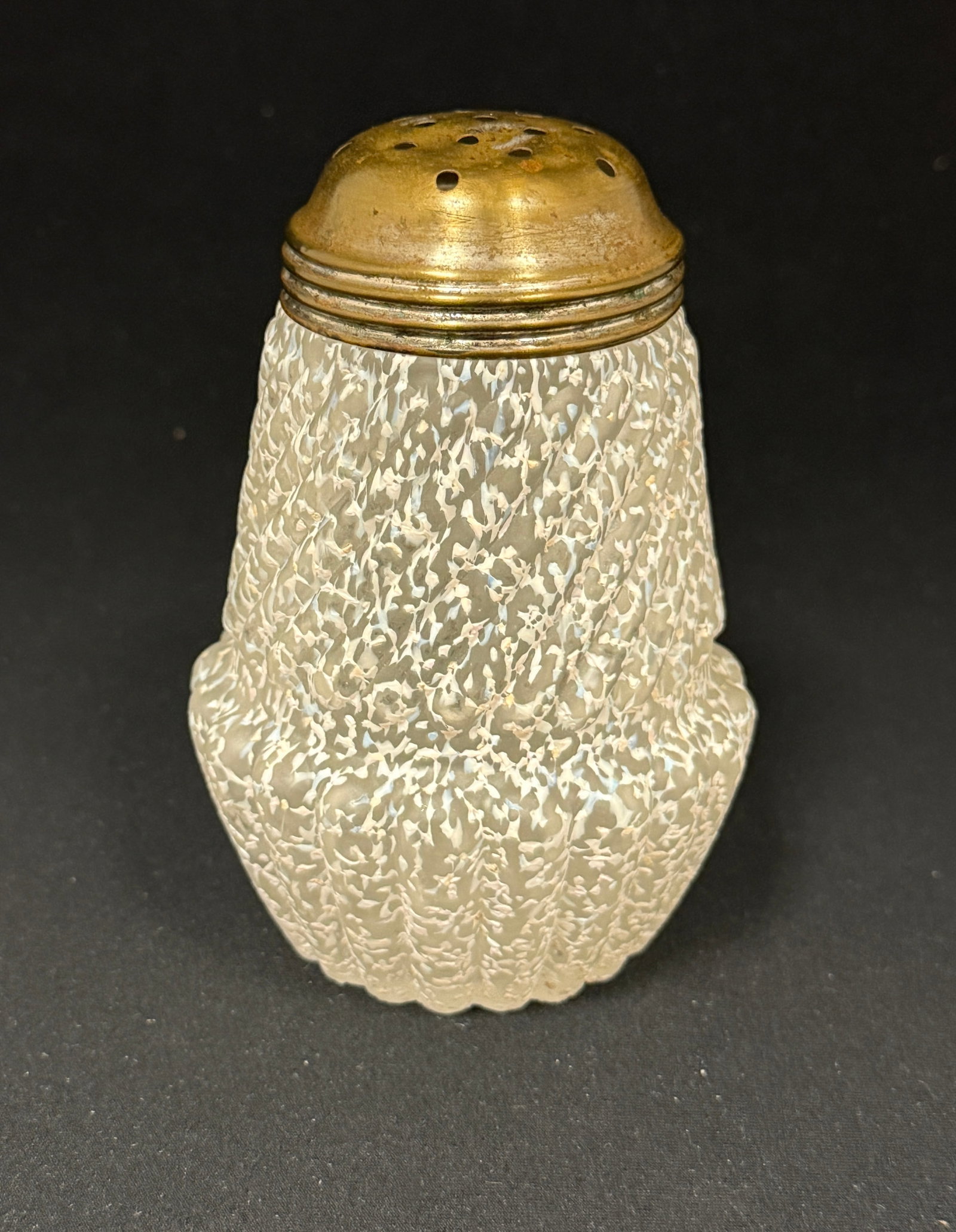 Chrysanthemum Base Shaker: Opalescent white splatter chrysanthemum base sugar shaker; ht. 4 3/4". CONDITION: chips on rim.
