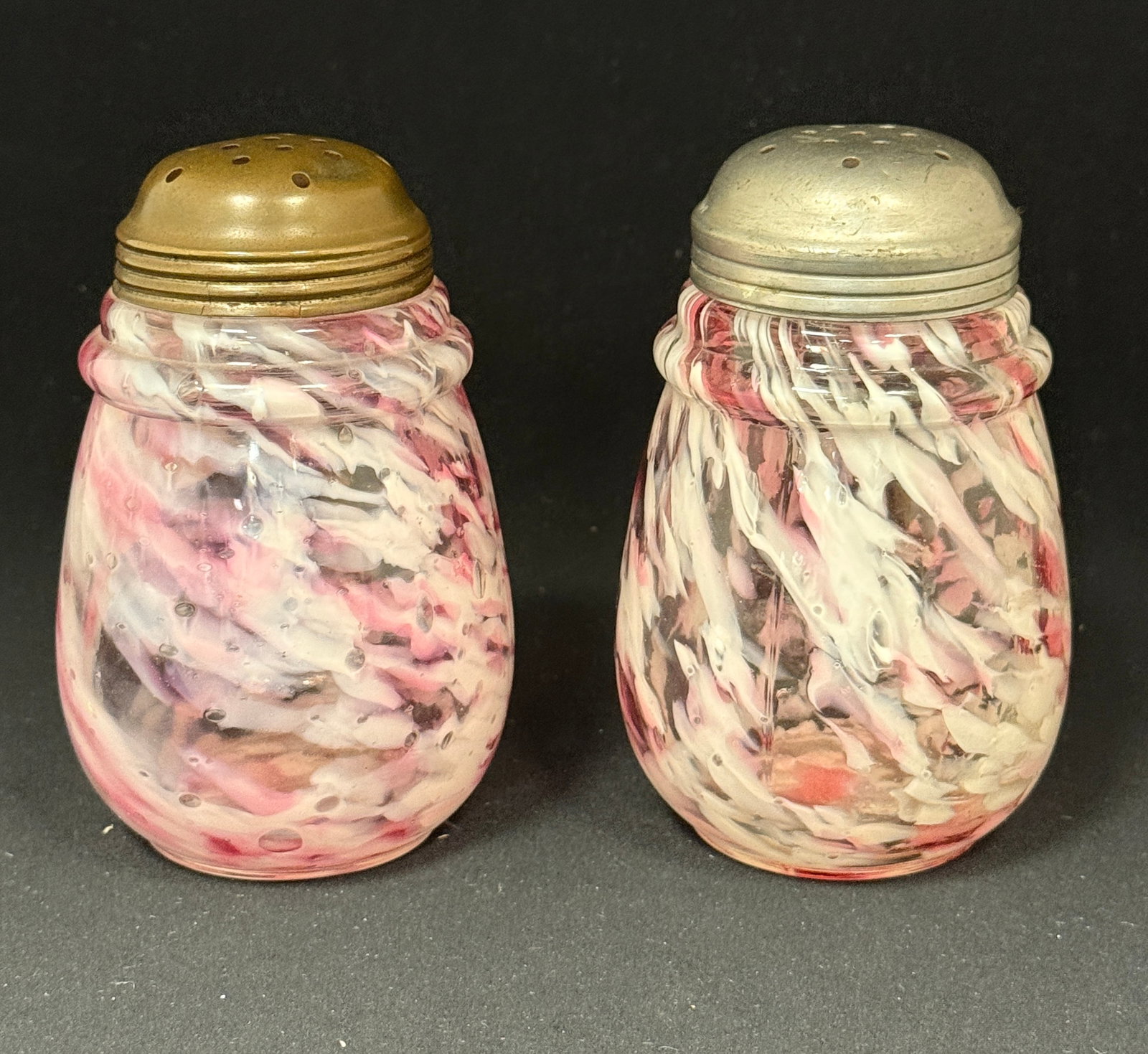 2 Cranberry Splatter Shakers: 2 cranberry splatter sugar shakers; ht. 5". CONDITION: no chips, cracks, repairs, or material defects found, Jaremos attempts to call any material flaw that affects the price, but minor scratches and 