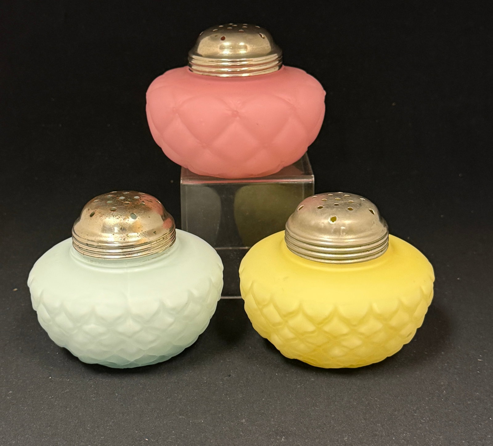 3 Squatty Cone Sugar Shakers: 3 squatty cone sugar shakers in light blue, pink and yellow; ht. 3 1/8". CONDITION: pink has chip on rim.