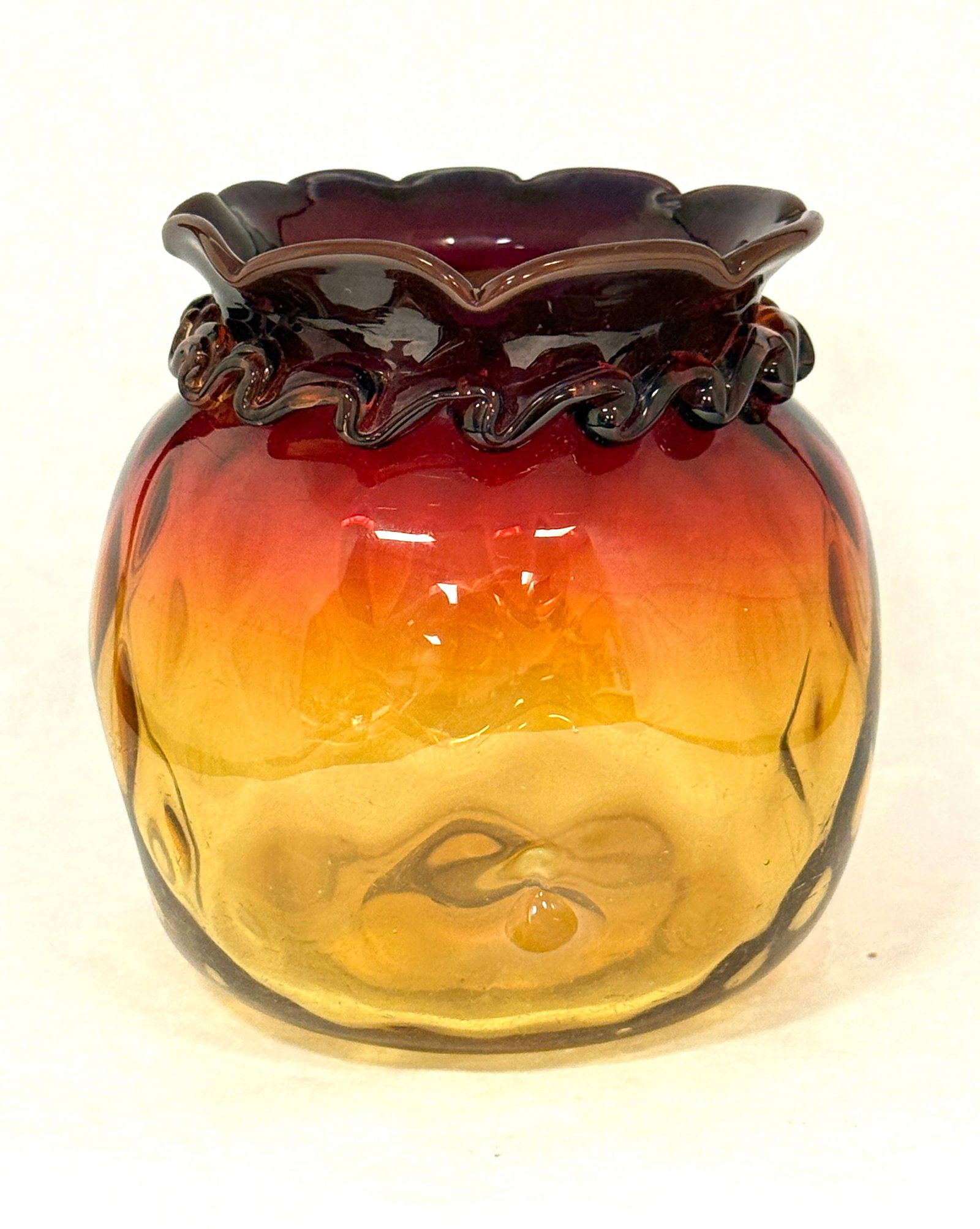 Amberina Rigaree Glass Vase: New England Amberina dimpled ovoid vase with a ruffled rim and rigaree collar, 5" ht. CONDITION: no chips, cracks, repairs, or material defects found, Jaremos attempts to call any material flaw that