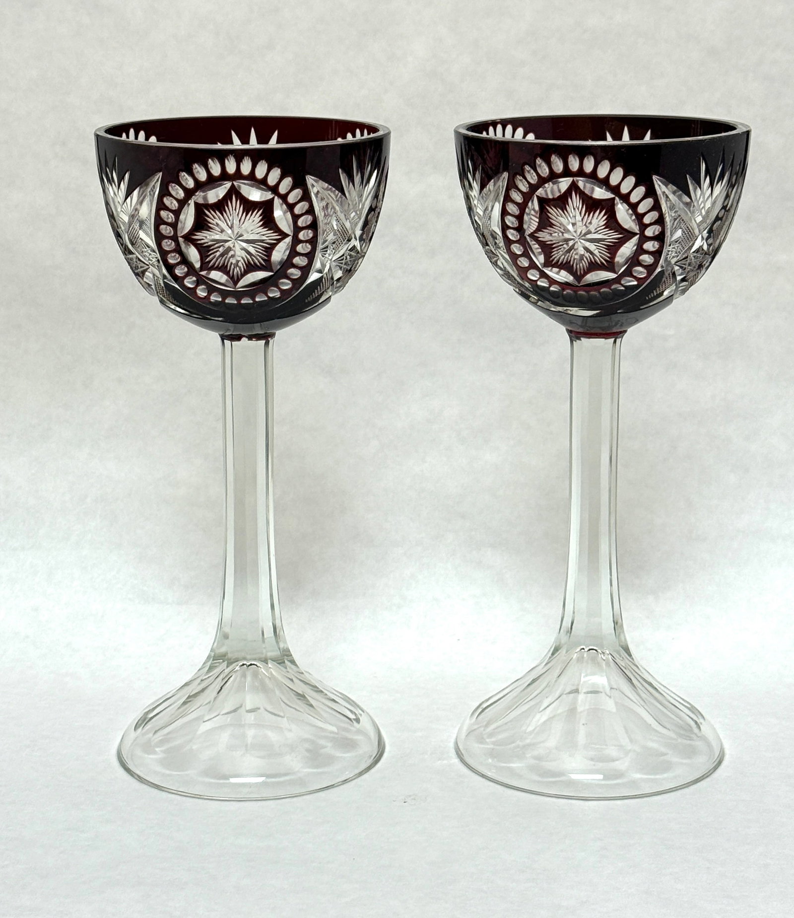 2 BPCG Cut to Clear Goblets: 2 BPCG cut to clear goblets, dark red cut to clear, Bohemian; diameter 3 7/8" ht. 8 3/4". CONDITION: no chips, cracks, repairs or material defects found. Jaremos attempts to call any material flaw tha