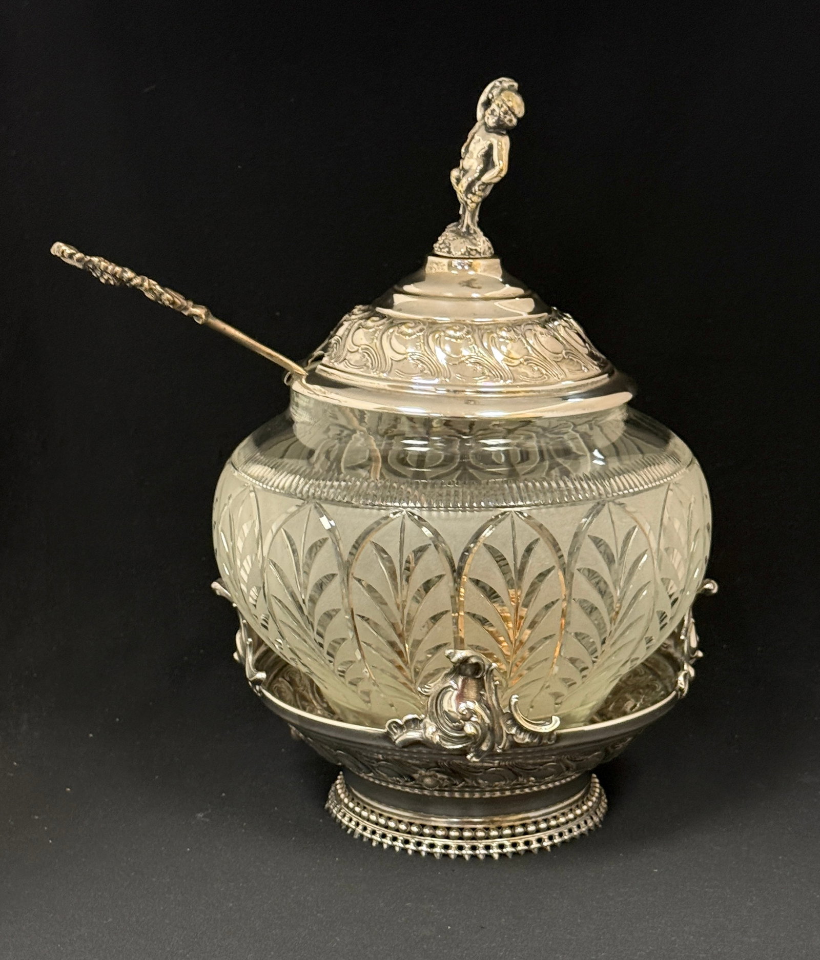 Cut Glass Punch Bowl in Holder: Cut glass punch bowl in silver plate holder with pontii finial, includes ladle; ht. 15". CONDITION: no chips, cracks, repairs, or material defects found, Jaremos attempts to call any material flaw