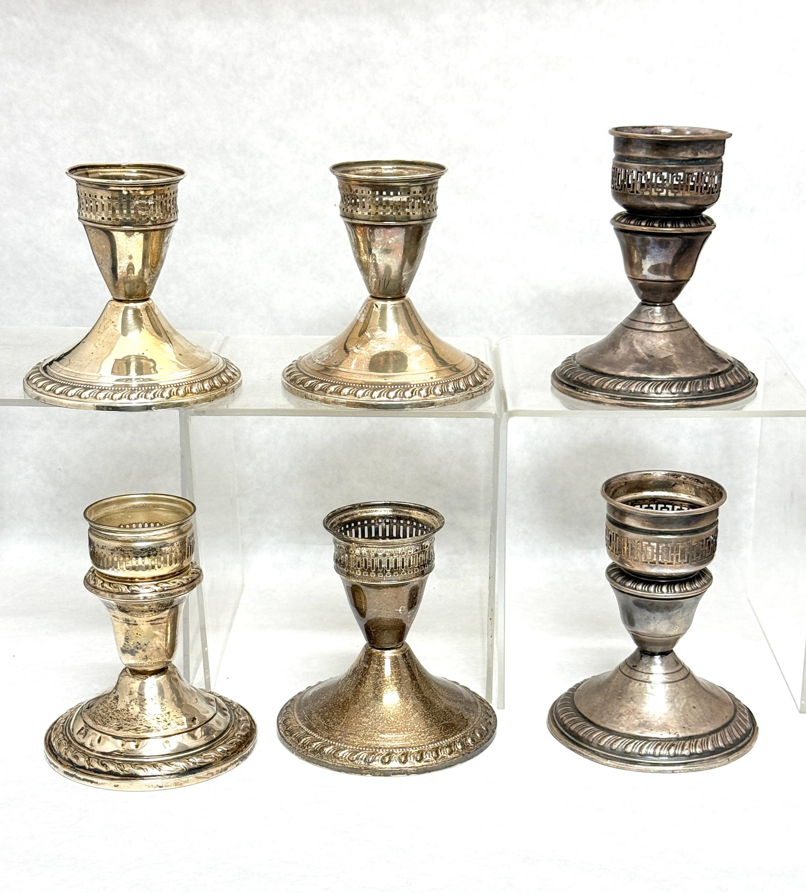 6 Sterling Candle Sticks: 6 sterling candle sticks; tallest 4". CONDITION: no chips, cracks, repairs, or material defects found, Jaremos attempts to call any material flaw that affects the price, but minor scratches and color