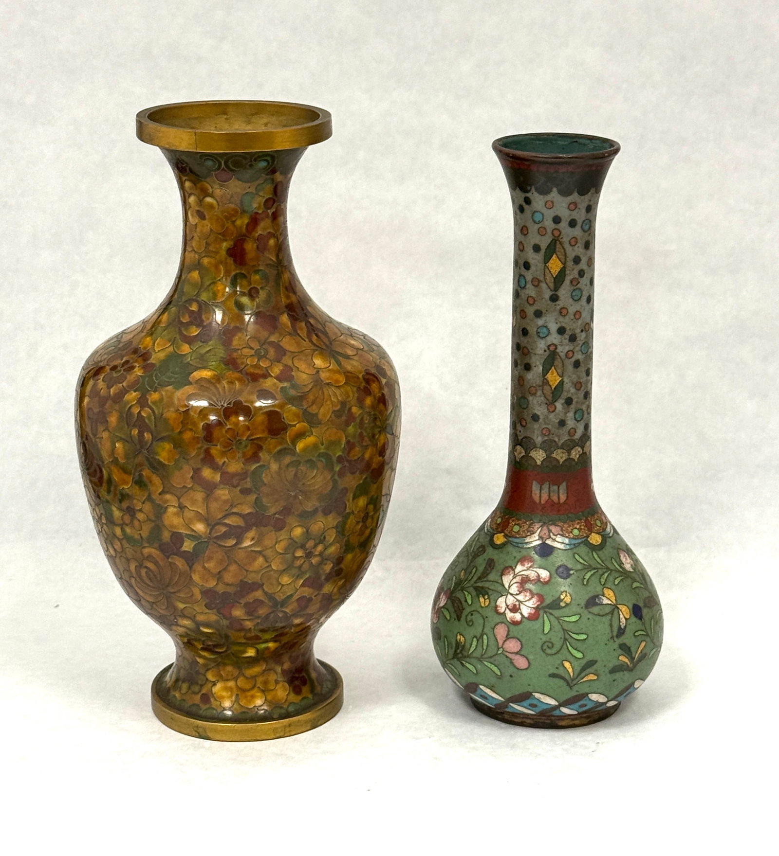 2 Cloisonne Vases: 2 Cloisonne vases; tallest 7 3/4". CONDITION: no chips, cracks, repairs, or material defects found, Jaremos attempts to call any material flaw that affects the price, but minor scratches and color