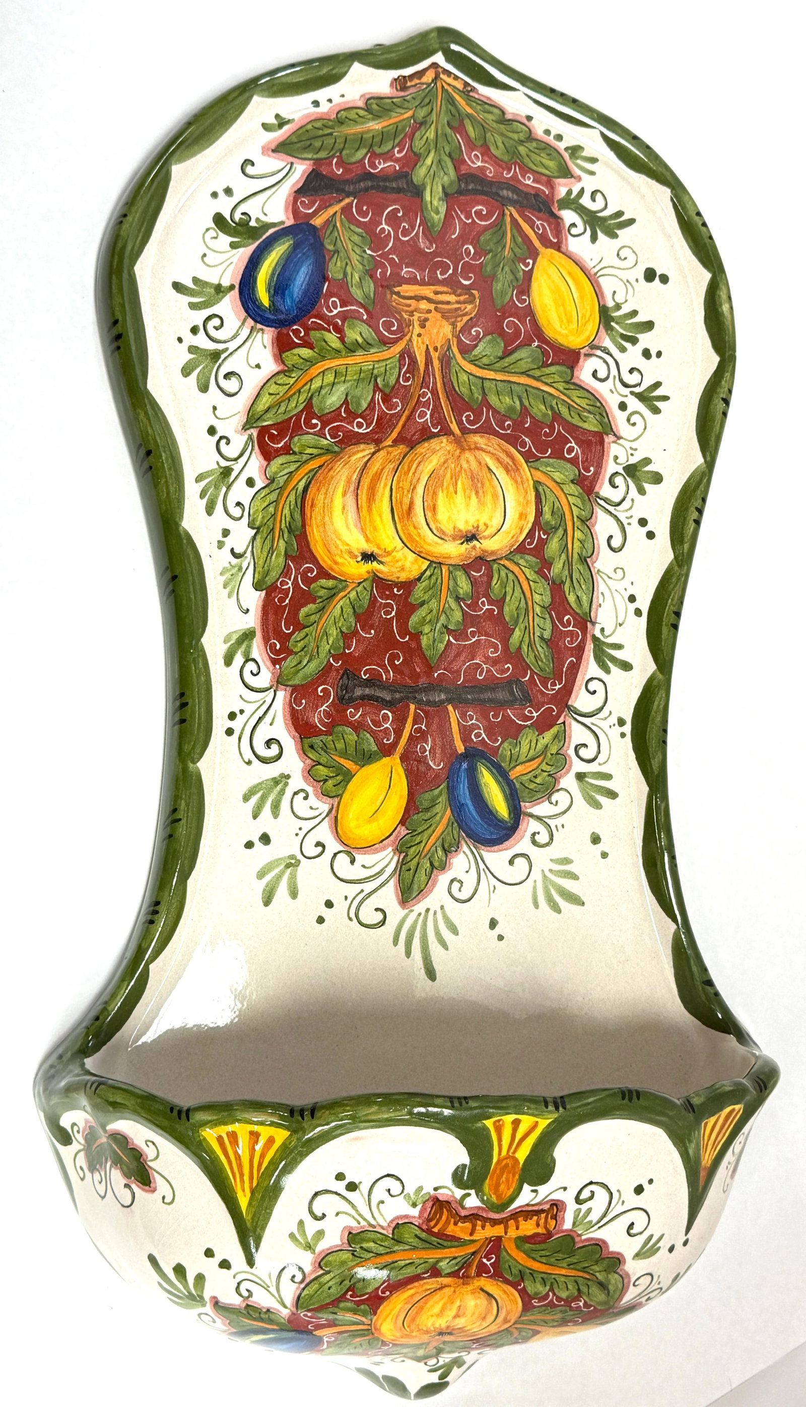 Deruta Hanging Wall Font: Deruta hanging wall water font with hanging hand painted fruit, signed Artistica Deruta Made in Italy; length 24 1/4". CONDITION: no chips, cracks, repairs, or material defects found, Jaremos attempts