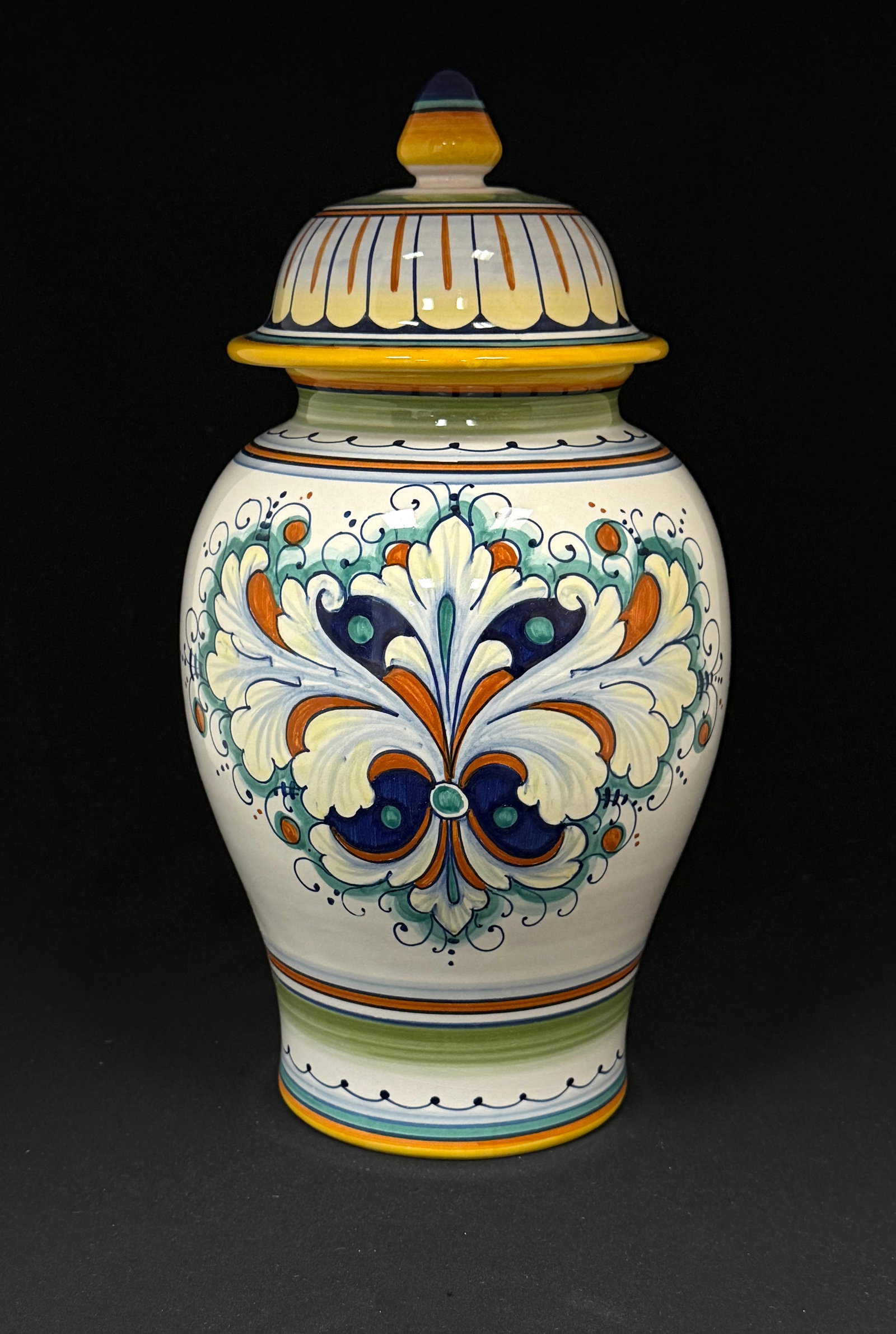 Deruta Covered Urn: Deruta covered urn with colorful flowery Fleur de Lis on white, signed hand painted in Deruta Made in Italy 83/100; CONDITION: no chips, cracks, repairs, or material defects found, Jaremos attempts to