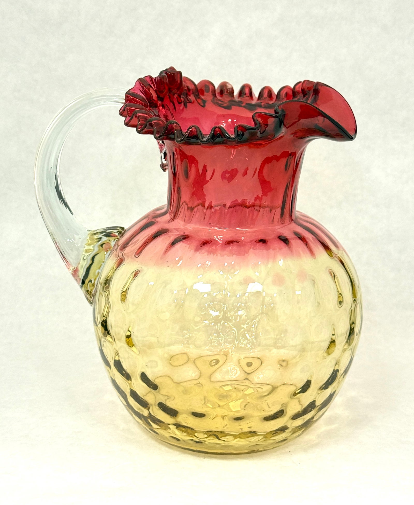Amberina Honey Comb Pitcher: Amberina Honey Comb Optic water pitcher with a ruffled rim, 8 3/4" ht. CONDITION: no chips, cracks, repairs, or material defects found, Jaremos attempts to call any material flaw that affects the