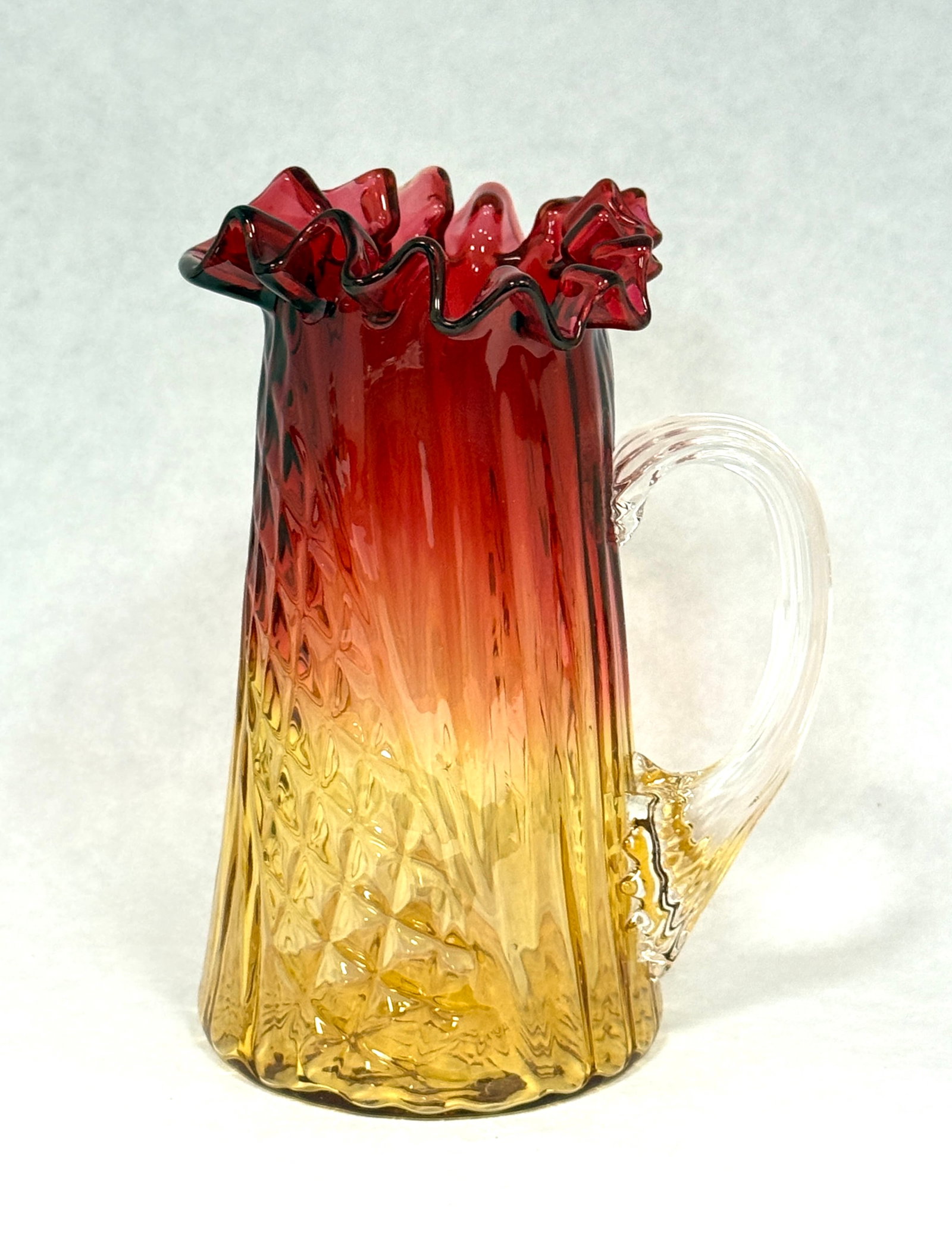 Amberina Ruffle Rim Pitcher: Amberina diagonal rib and diamond ruffle rim small pitcher; ht. 5 1/4. CONDITION: no chips, cracks, repairs, or material defects found, Jaremos attempts to call any material flaw that affects the