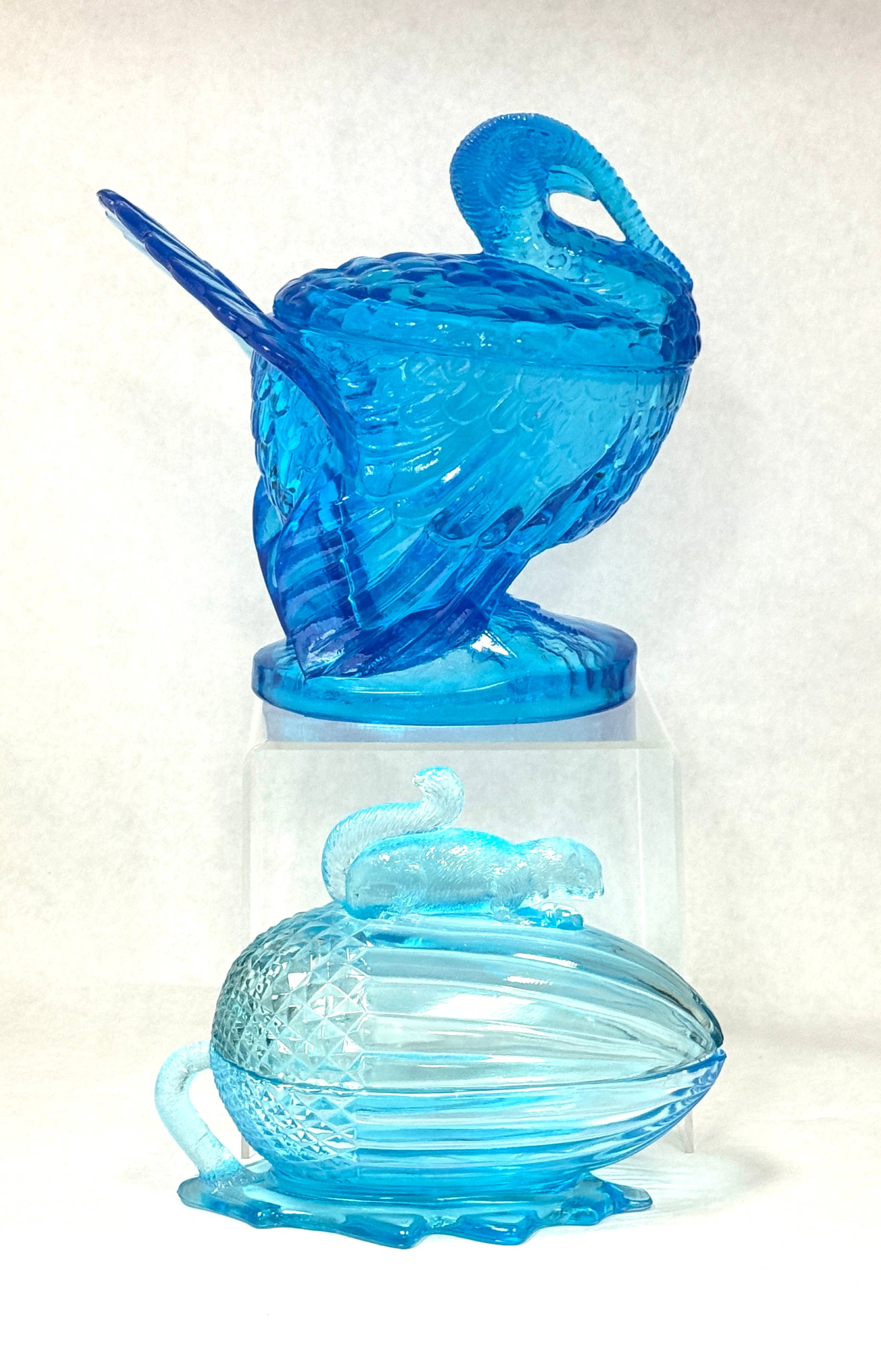 2 LE Smith Blue Items: 2 LE Smith blue items including a covered turkey dish and an acorn dish with squirrel; turkey ht. 8 1/2". CONDITION: no chips, cracks, repairs, or material defects found, Jaremos attempts to call any