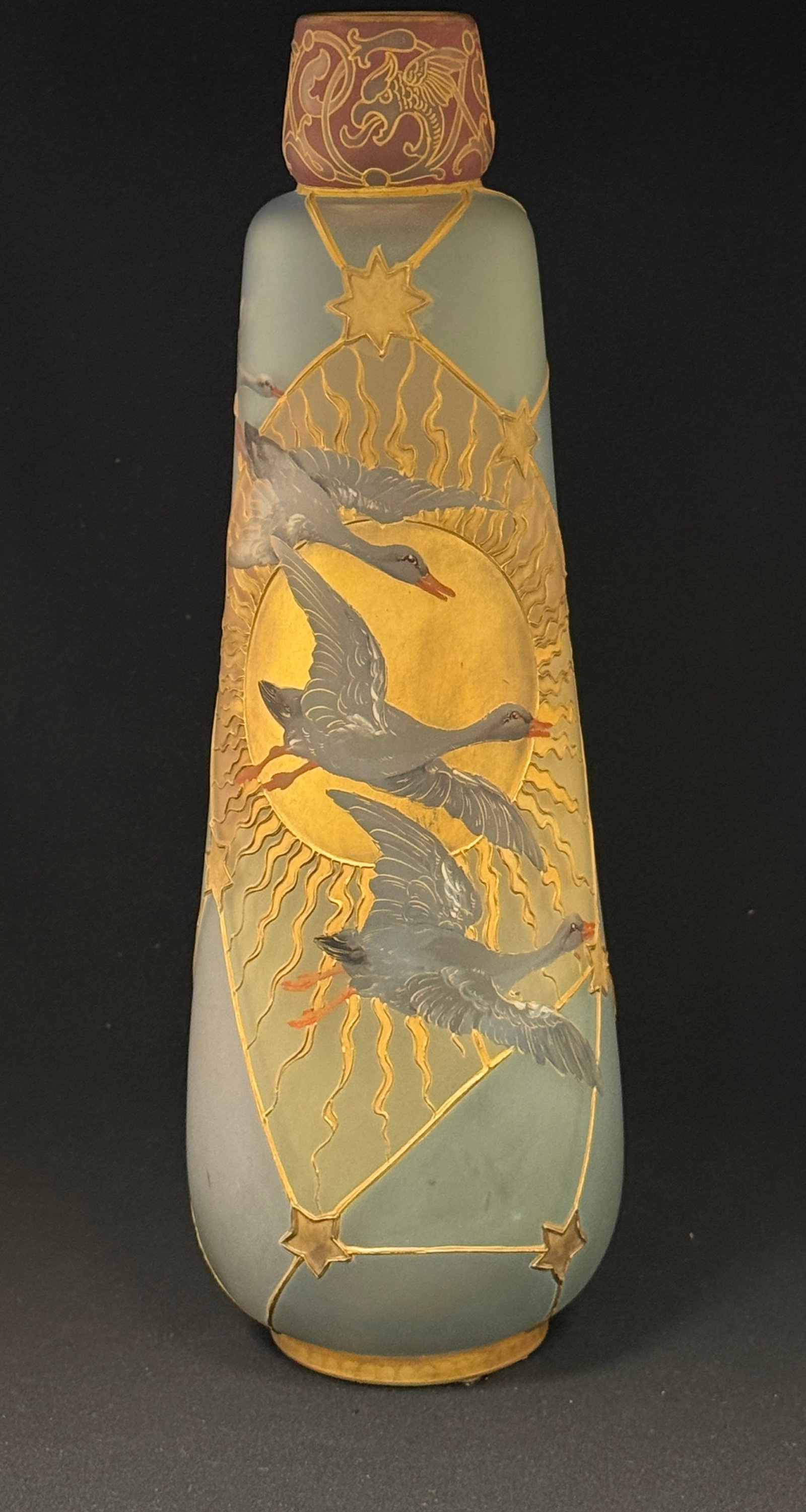 Mt. Washington Royal Flemish: Mt Washington Royal Flemish glass vase, cylindrical form with raised gold panels of blue glass decorated with flying geese in front of a blazing sun 14 1/2" ht. CONDITION: no chips, cracks, repairs,