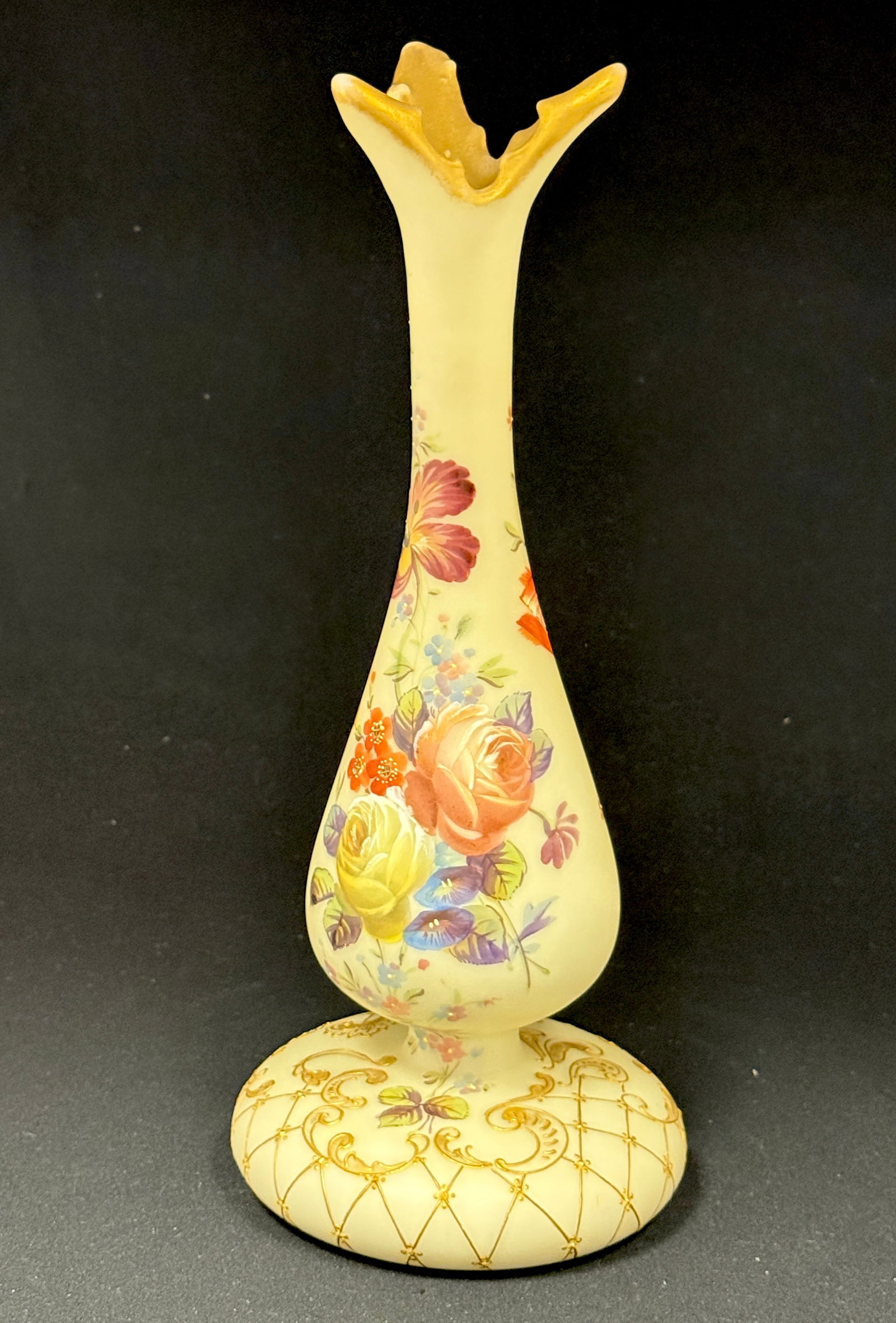 Mt. Washington Colonial Ware: Mt. Washington Colonial Ware footed bud vase with a triple bird beak rim decorated with a cluster of colorful roses, lattice and scrolling foot, red wreath mark, 12" ht. CONDITION: no chips, cracks,