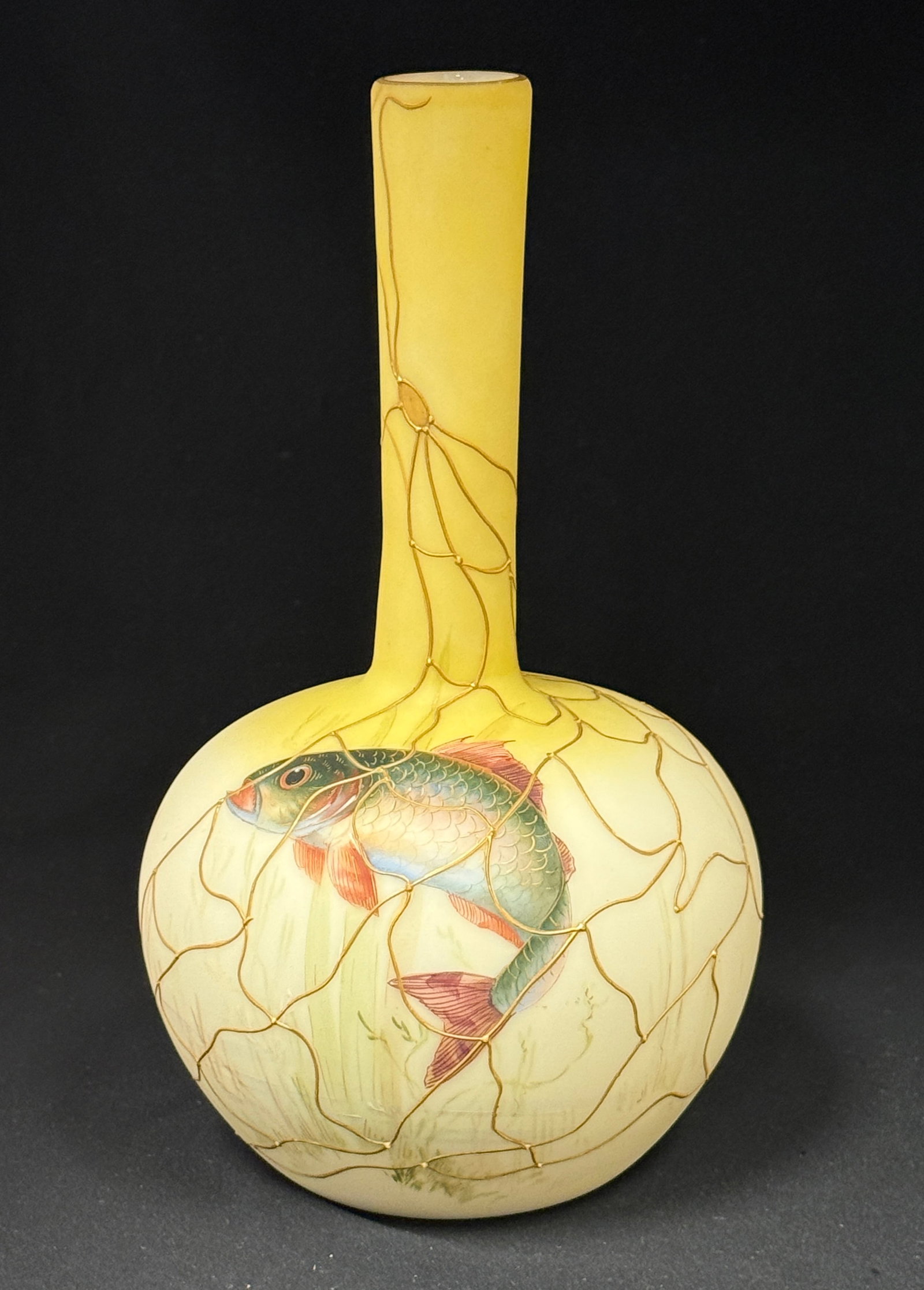 Mt Washington Fish Vase: Mt Washington Crown Milano fish vase, bulbous stick form in opal to yellow glass decorated with a blue fish in gold net, 10" ht; CONDITION: no chips, cracks, repairs, or material defects found,