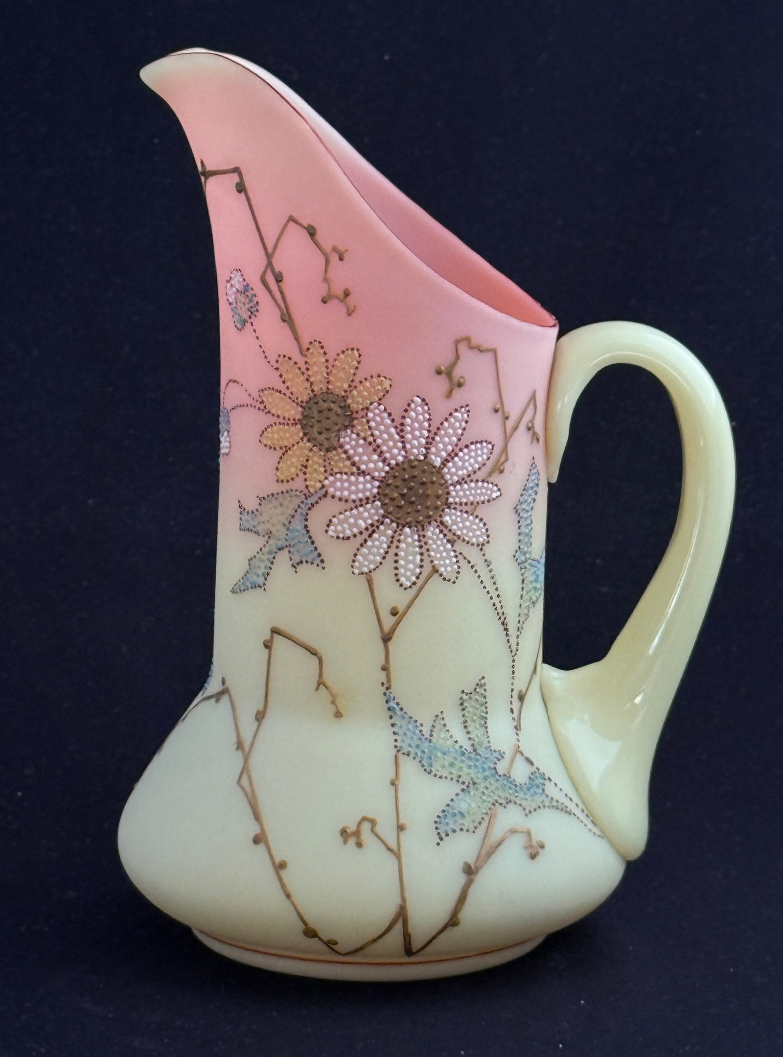 Mt. Washington Burmese Pitcher: Mt. Washington Burmese pitcher decorated with the Queens pattern of pointillism flowers, 7 1/2" ht. PROVENANCE: exhibited at the Mt. Washington Annual convention. CONDITION: no chips, cracks,