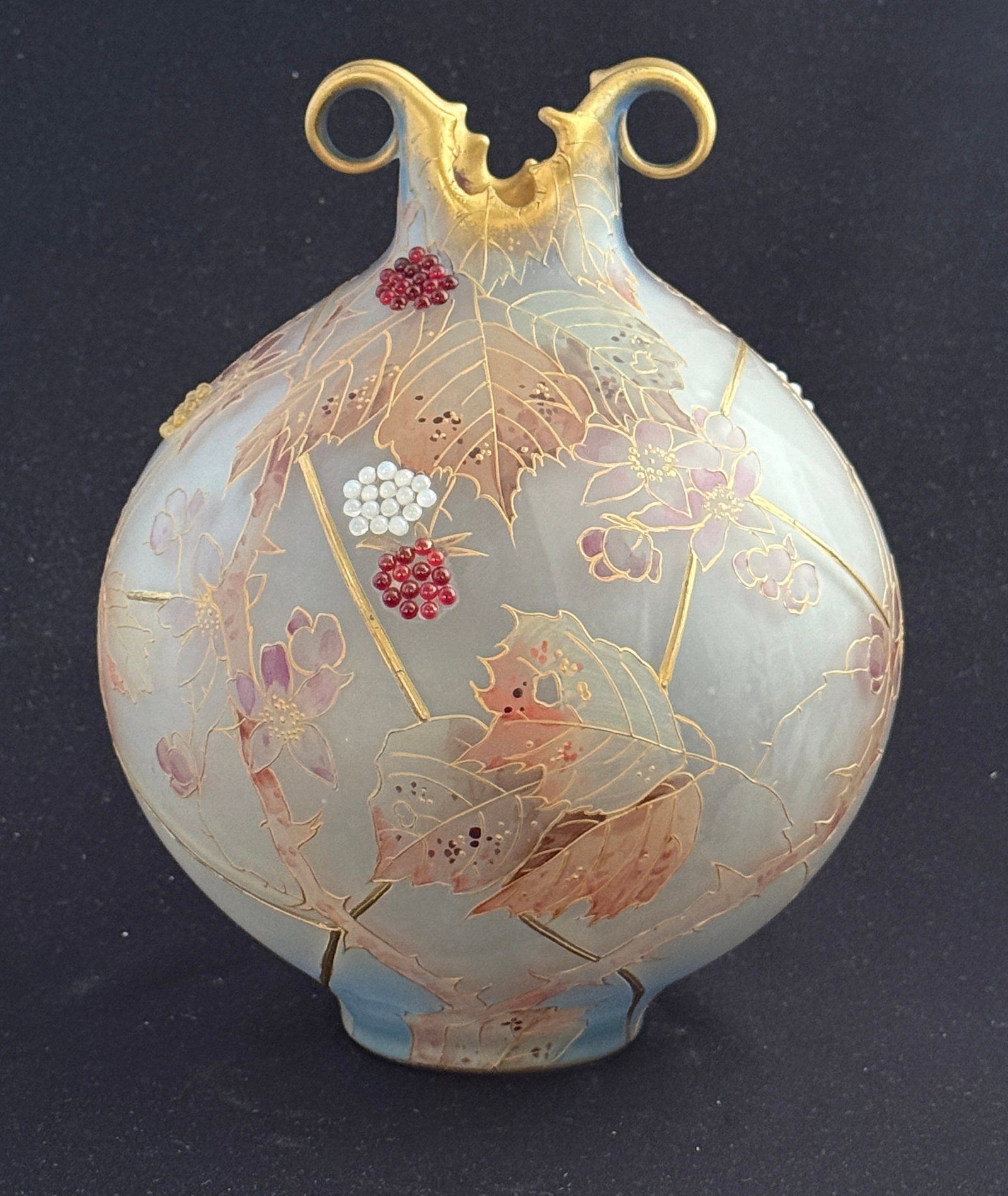 Mt Washington Royal Flemish Vase: Mt. Washington Royal Flemish vase, globular form with two scrolling handles, raised gold panels of blue glass with colorful oak leaves and clusters of red, yellow, and white berries, 9" ht.