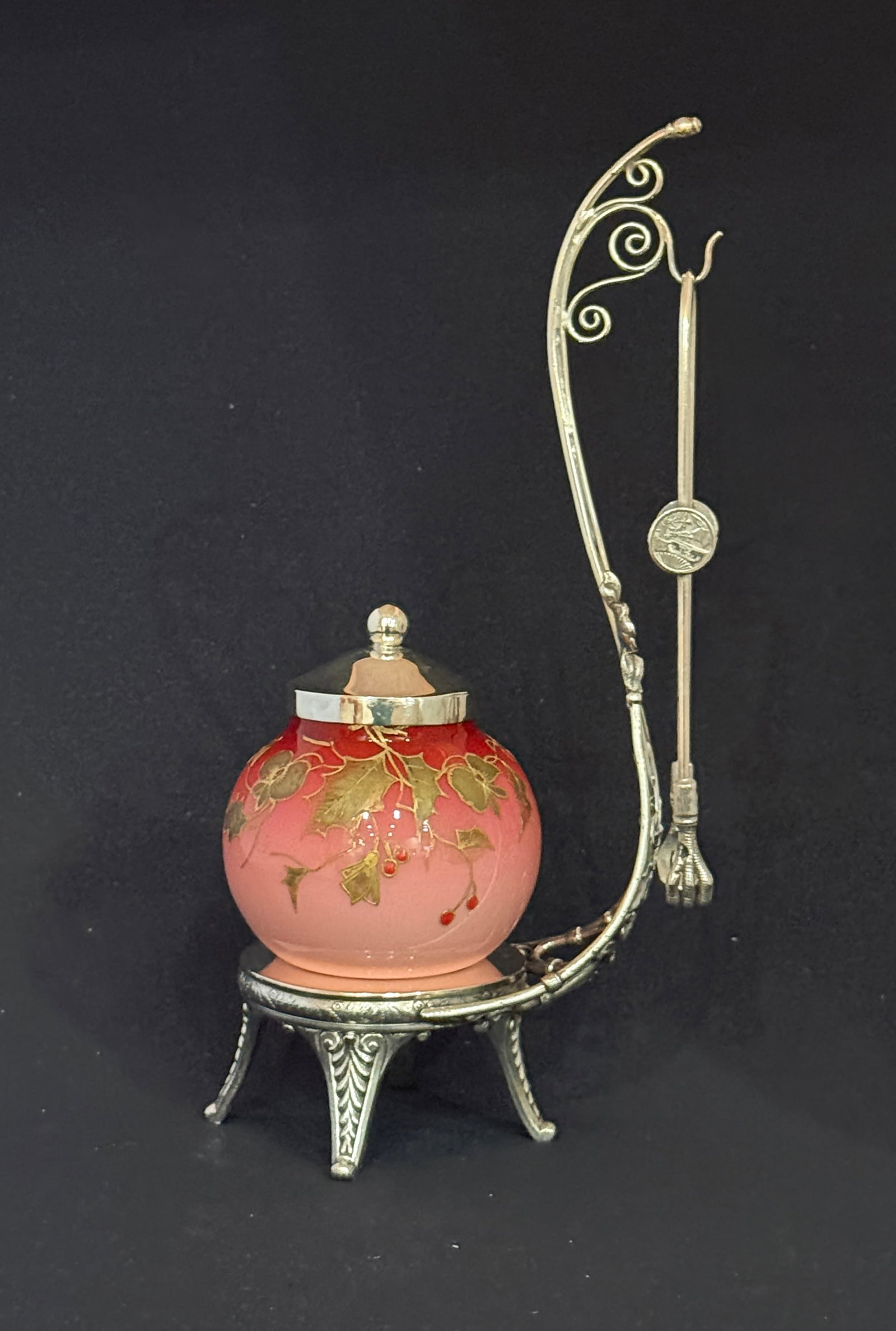Webb Peachblow pickle castor: Webb globular Peachblow glass pickle castor with gilt leaves set in a single arm embossed caddy, 10" ht. CONDITION: no chips, cracks, repairs, or material defects found, Jaremos attempts to call any m