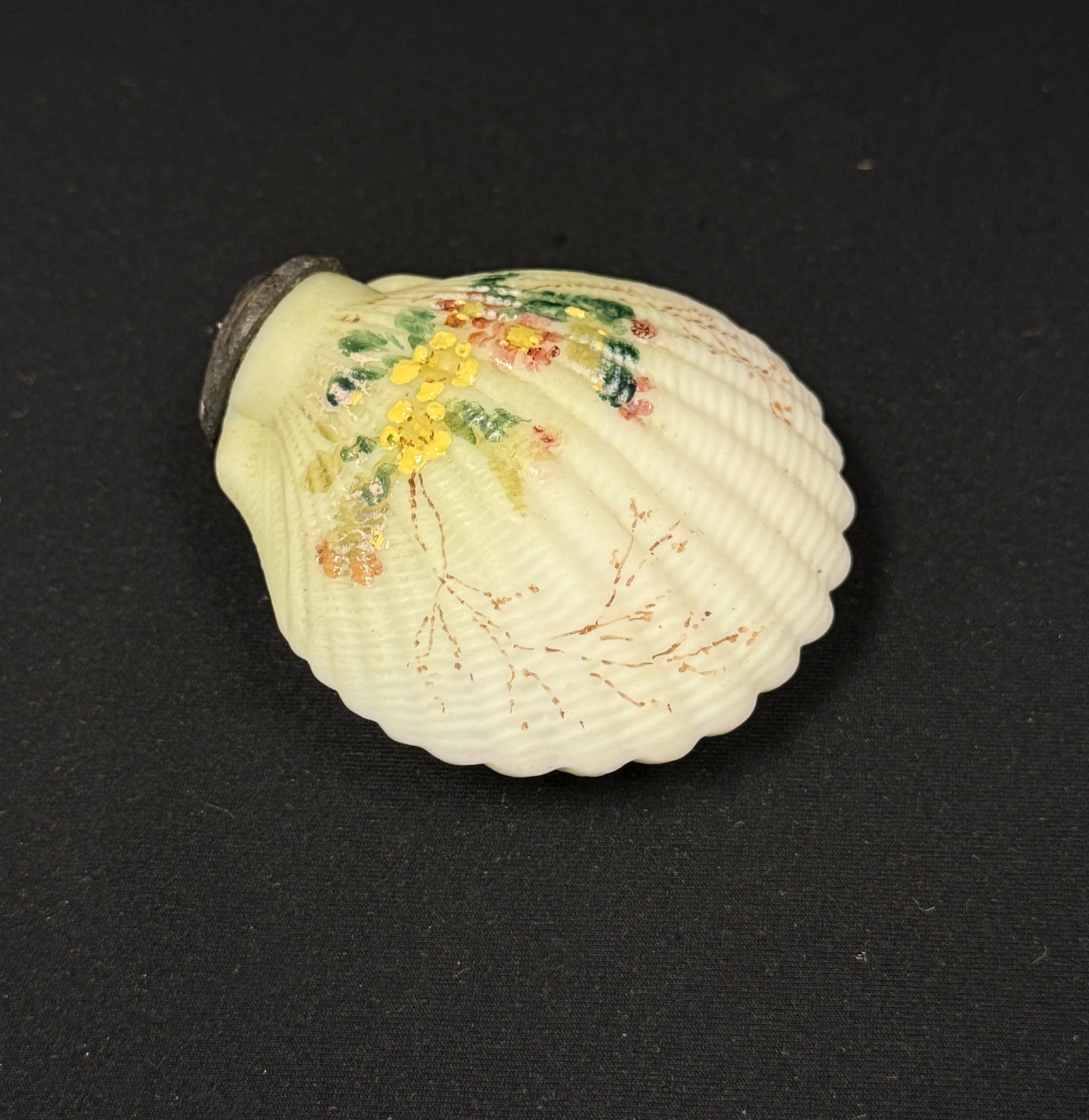 Mt. Washington Cockleshell Salt: Mt. Washington cockleshell salt shaker with yellow flowers; ht. 2 3/4". CONDITION: no chips, cracks, repairs, or material defects found, Jaremos attempts to call any material flaw that affects the