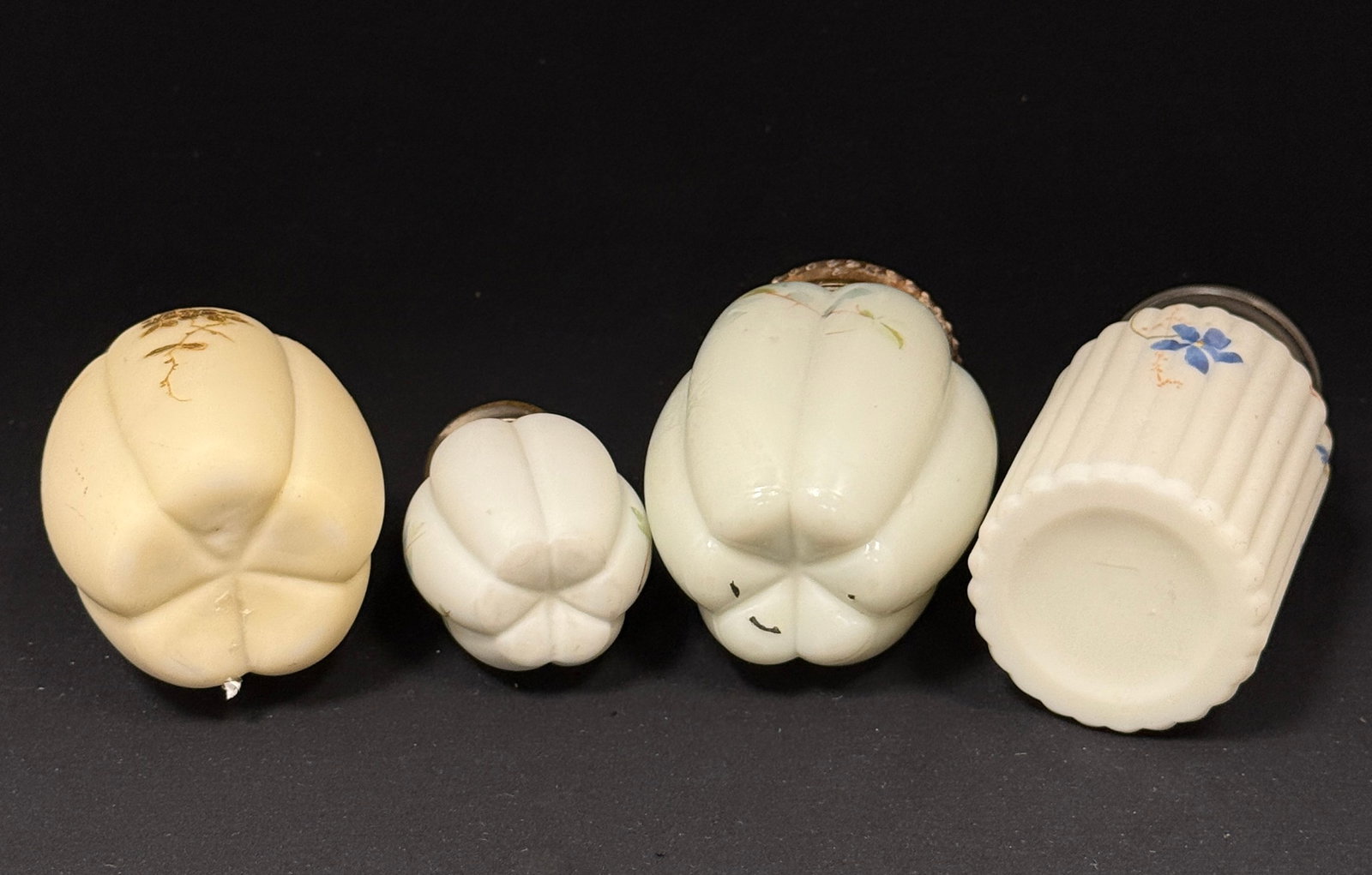 4 Victorian Shakers: 4 Victorian shakers including a Gillander melon sugar shaker and a salt, a Smith Brothers melon rib sugar shaker, and a Mt. Washington ribbed pillar sugar shaker; tallest 6". CONDITION: no chips,