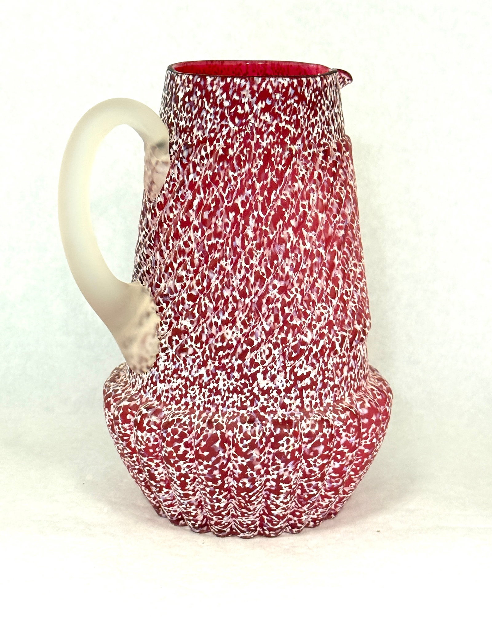 Northwood Splatter Pitcher: Northwood chrysanthemum base pitcher white splatter on cranberry, 9" ht. CONDITION: no chips, cracks, repairs, or material defects found, Jaremos attempts to call any material flaw that affects the pr