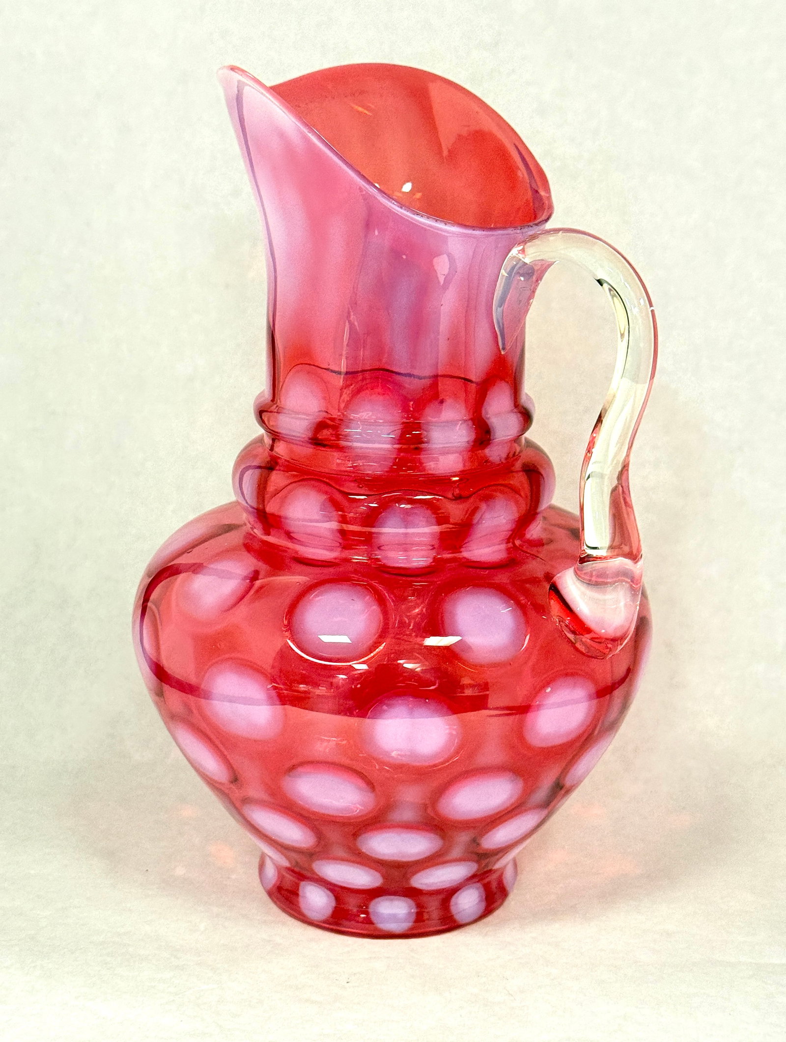 Opalescent Coin Spot Pitcher: Opalescent cranberry coin spot 3 tier pitcher; ht. 11 1/4". CONDITION: no chips, cracks, repairs, or material defects found, Jaremos attempts to call any material flaw that affects the price, but mino