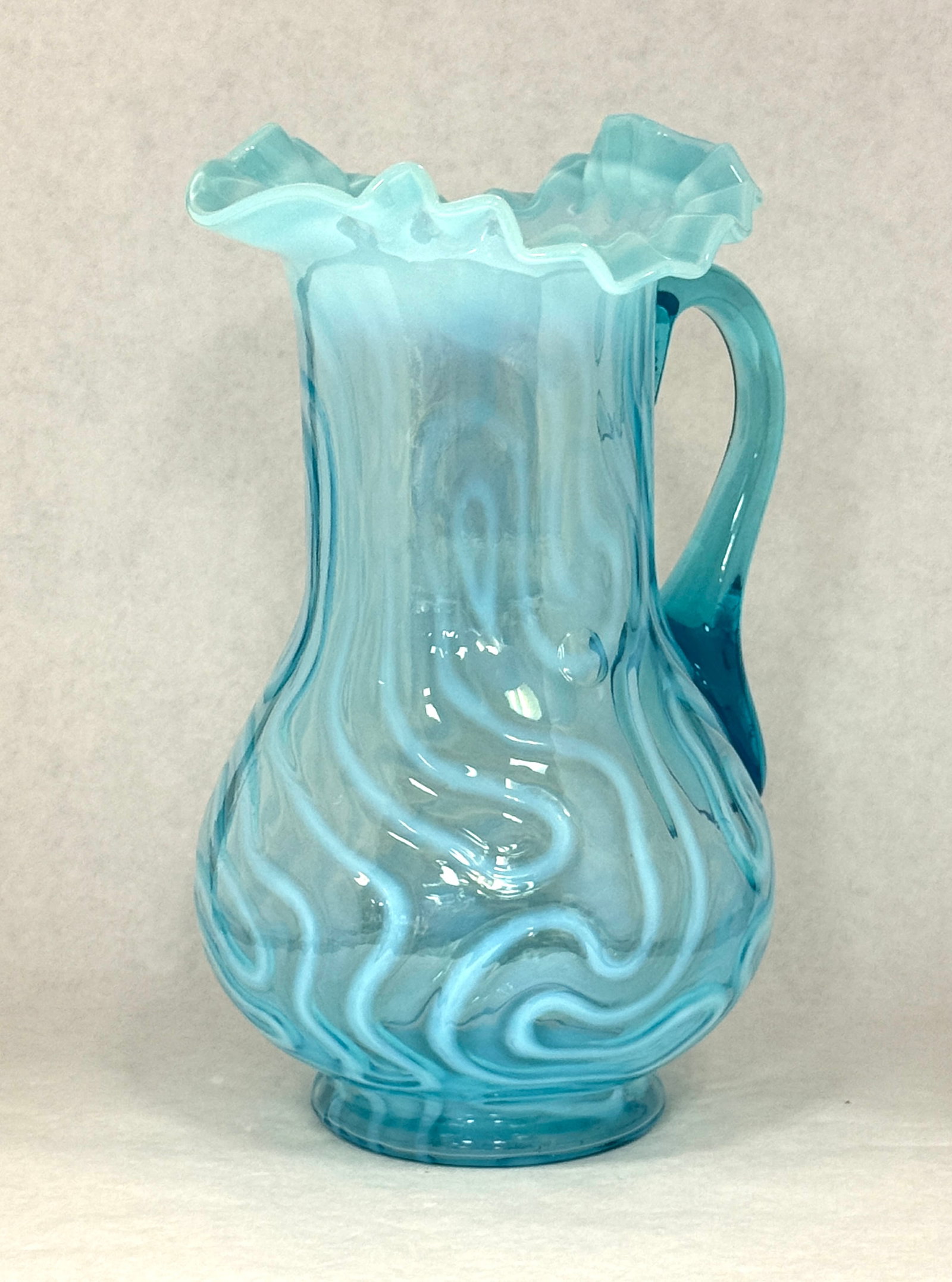 Opalescent Blue Maze Pitcher: Opalescent blue swirling maze pitcher; ht. 10 7/8". CONDITION: 3 internal bubbles, see picture.