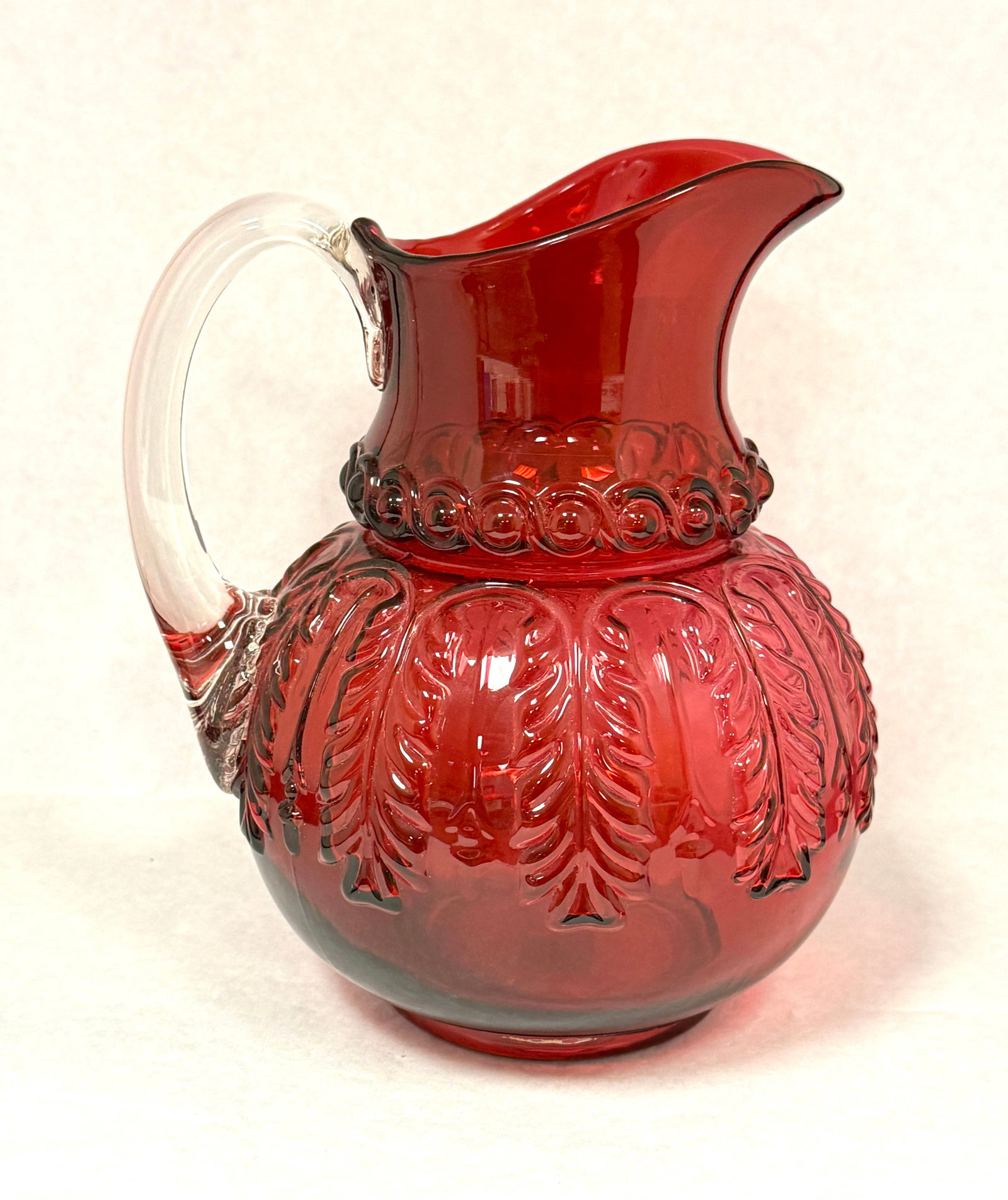 Cranberry Leaf Umbrella Pitcher: Cranberry leaf umbrella water pitcher; ht. 9". CONDITION: no chips, cracks, repairs, or material defects found, Jaremos attempts to call any material flaw that affects the price, but minor scratches